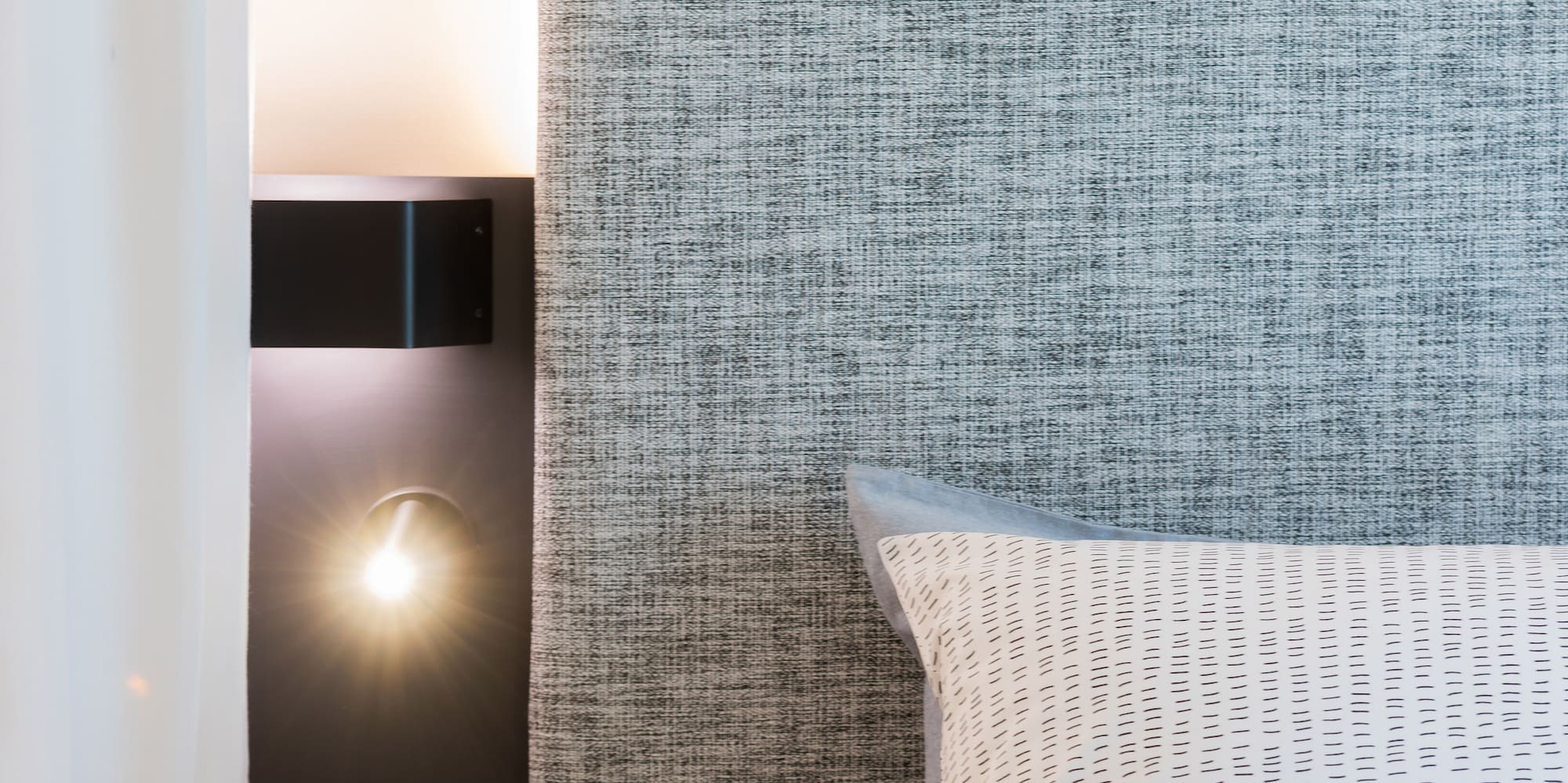 a bathroom with a bed and sink