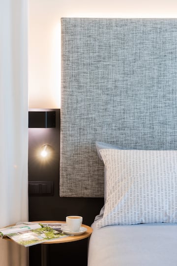 a bathroom with a bed and sink