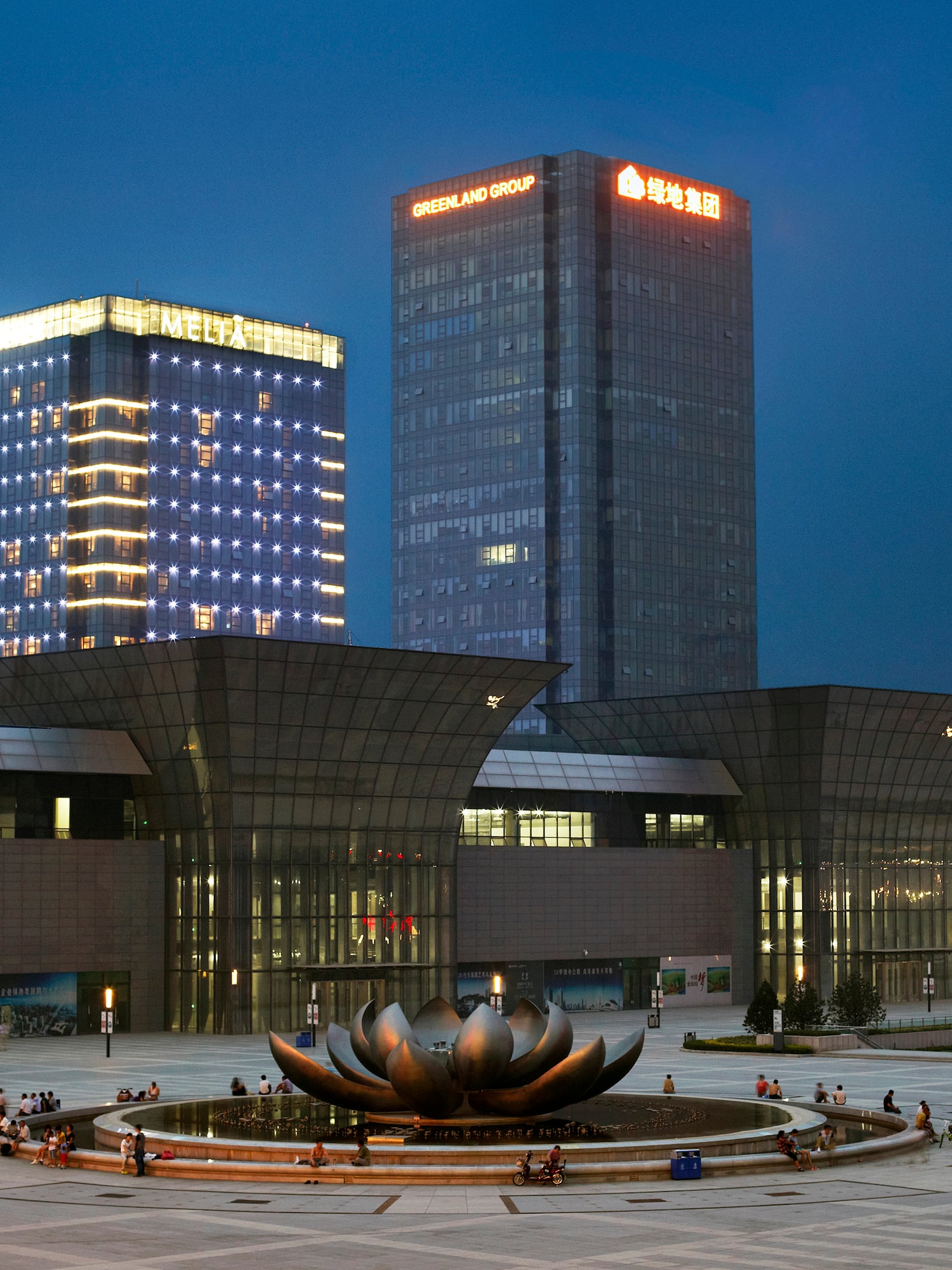 a large building with a fountain in front of it