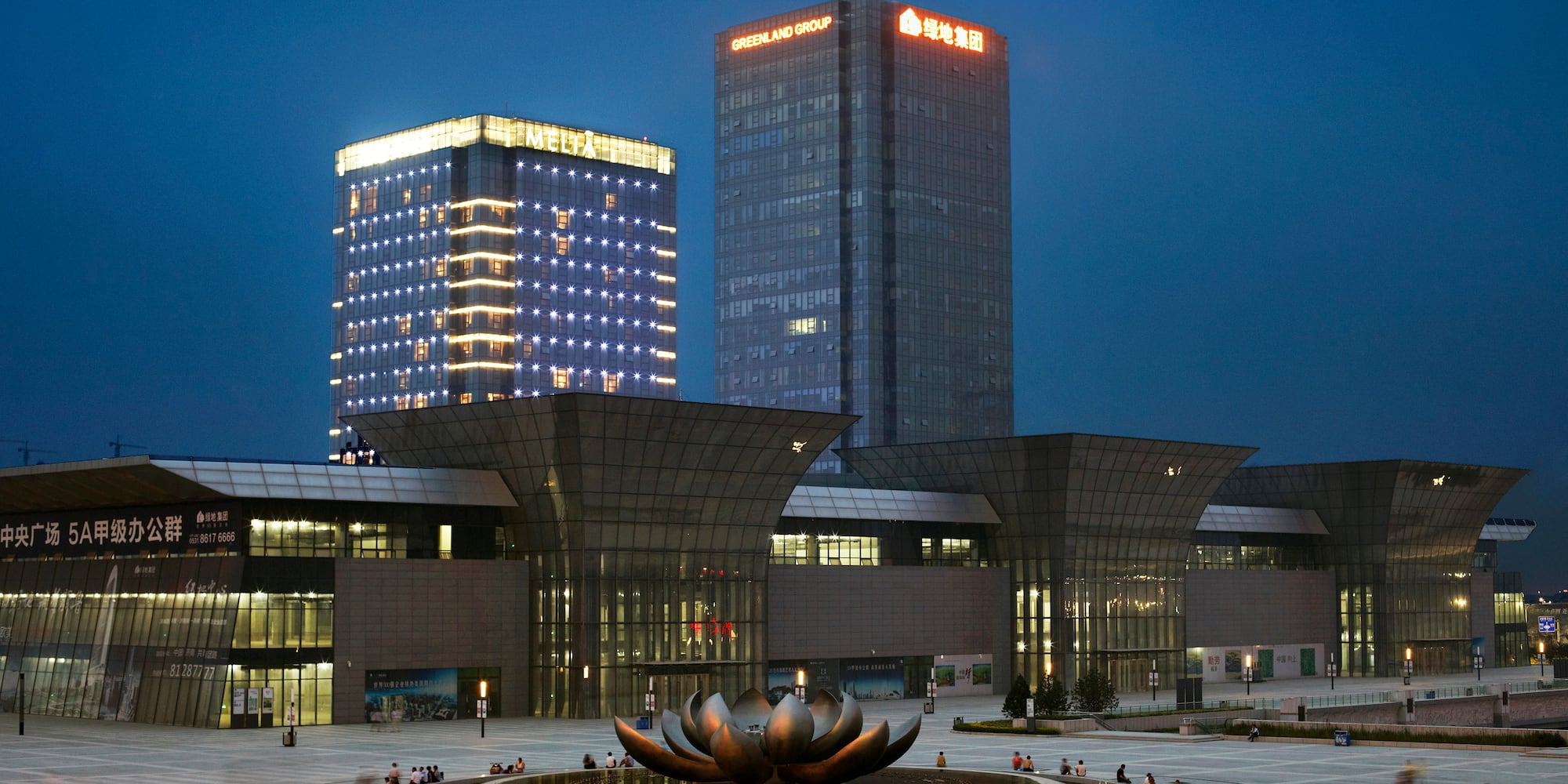 a large building with a fountain in front of it