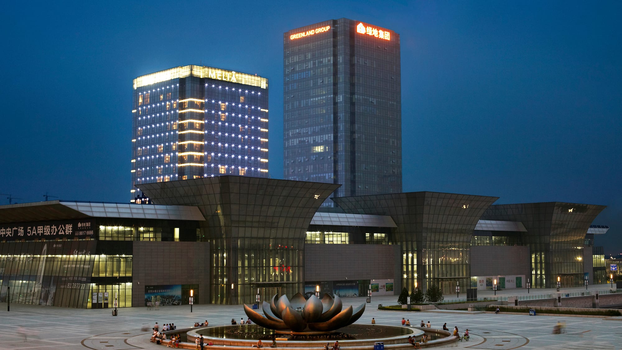 a large building with a fountain in front of it