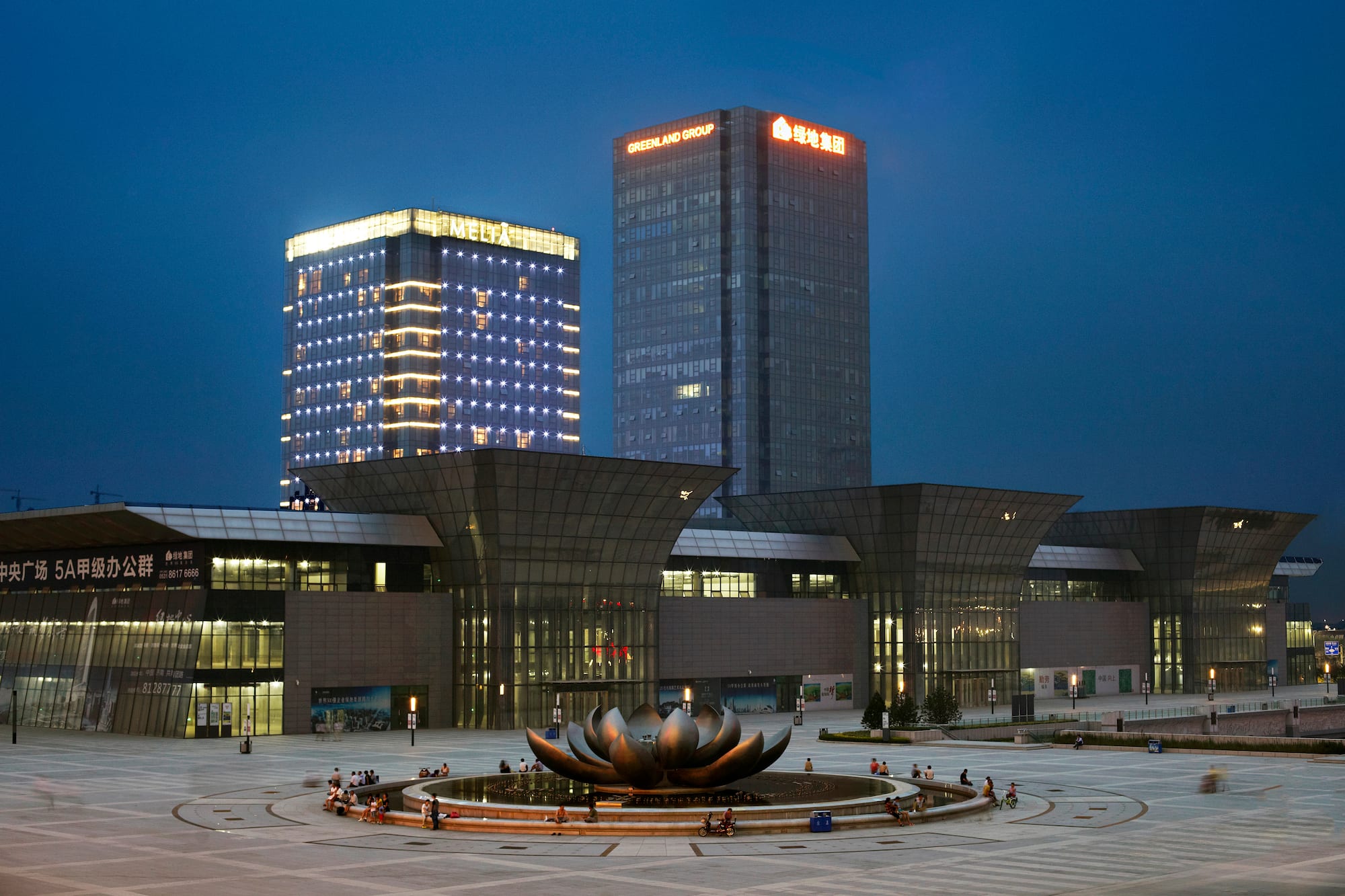 a large building with a fountain in front of it