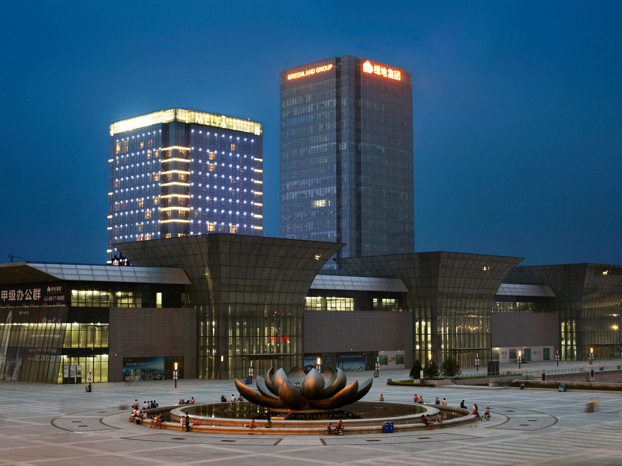 a large building with a fountain in front of it