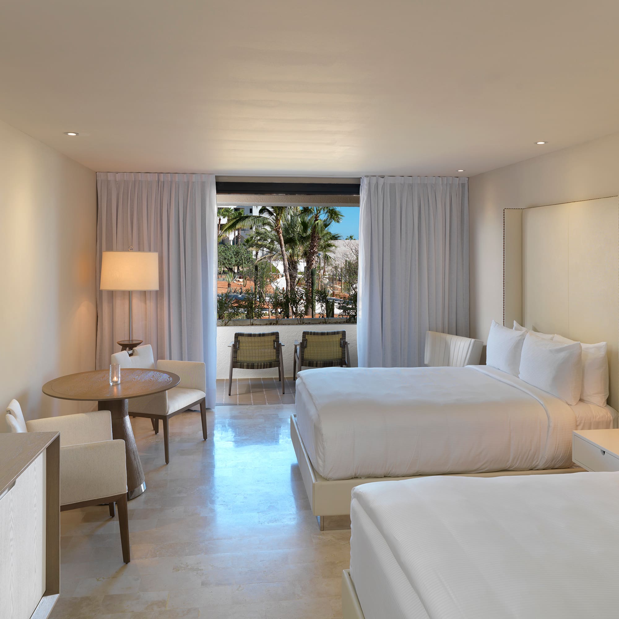 a room with two beds and a table