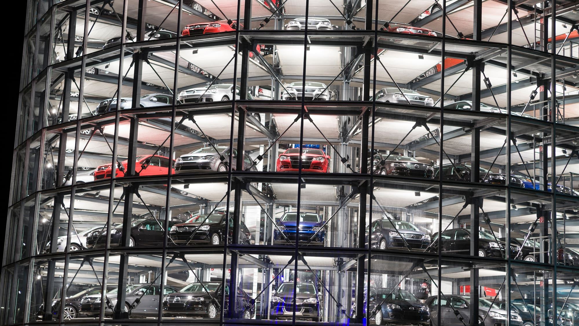 a car parking lot with many cars in a building