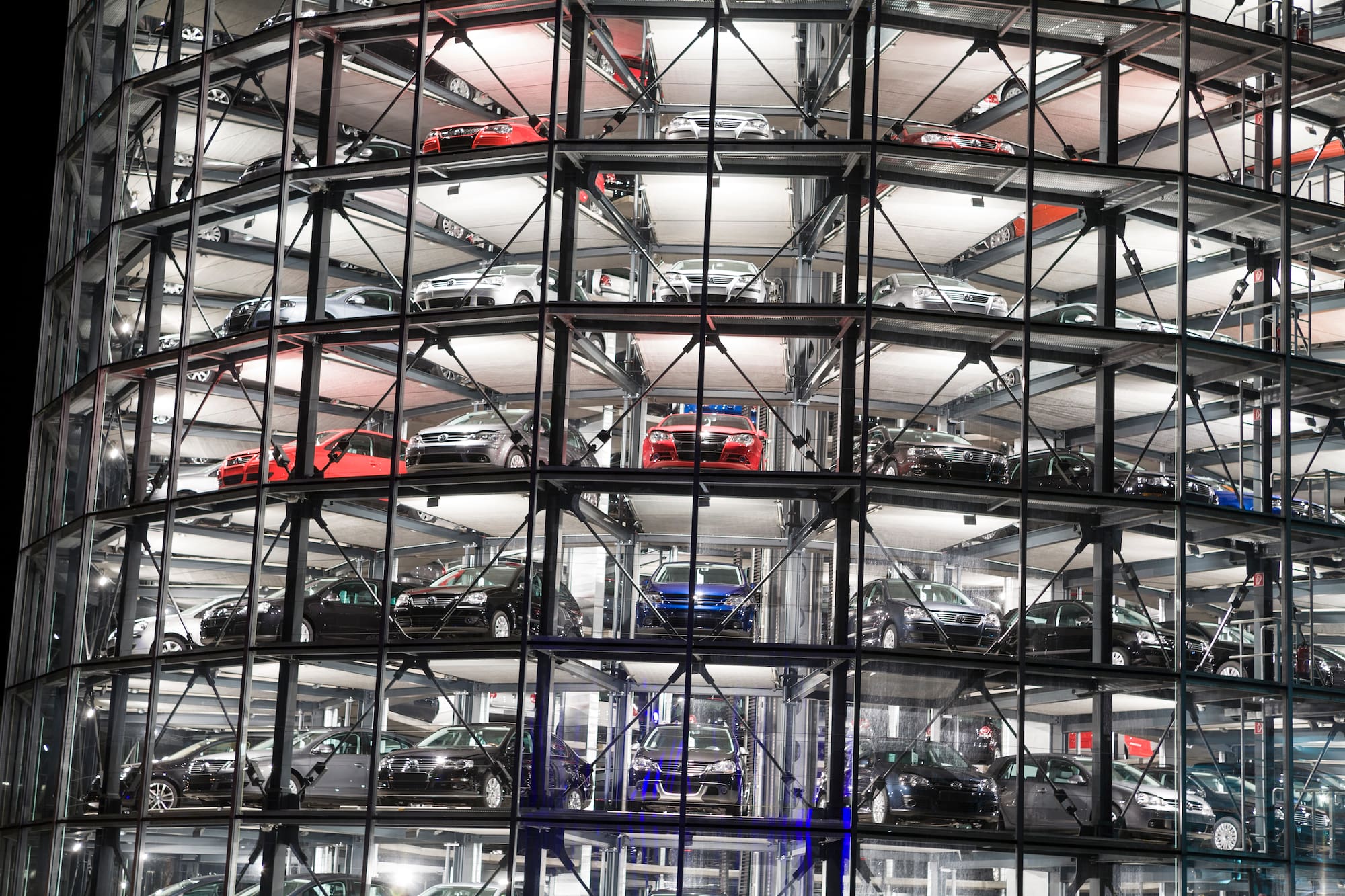 a car parking lot with many cars in a building