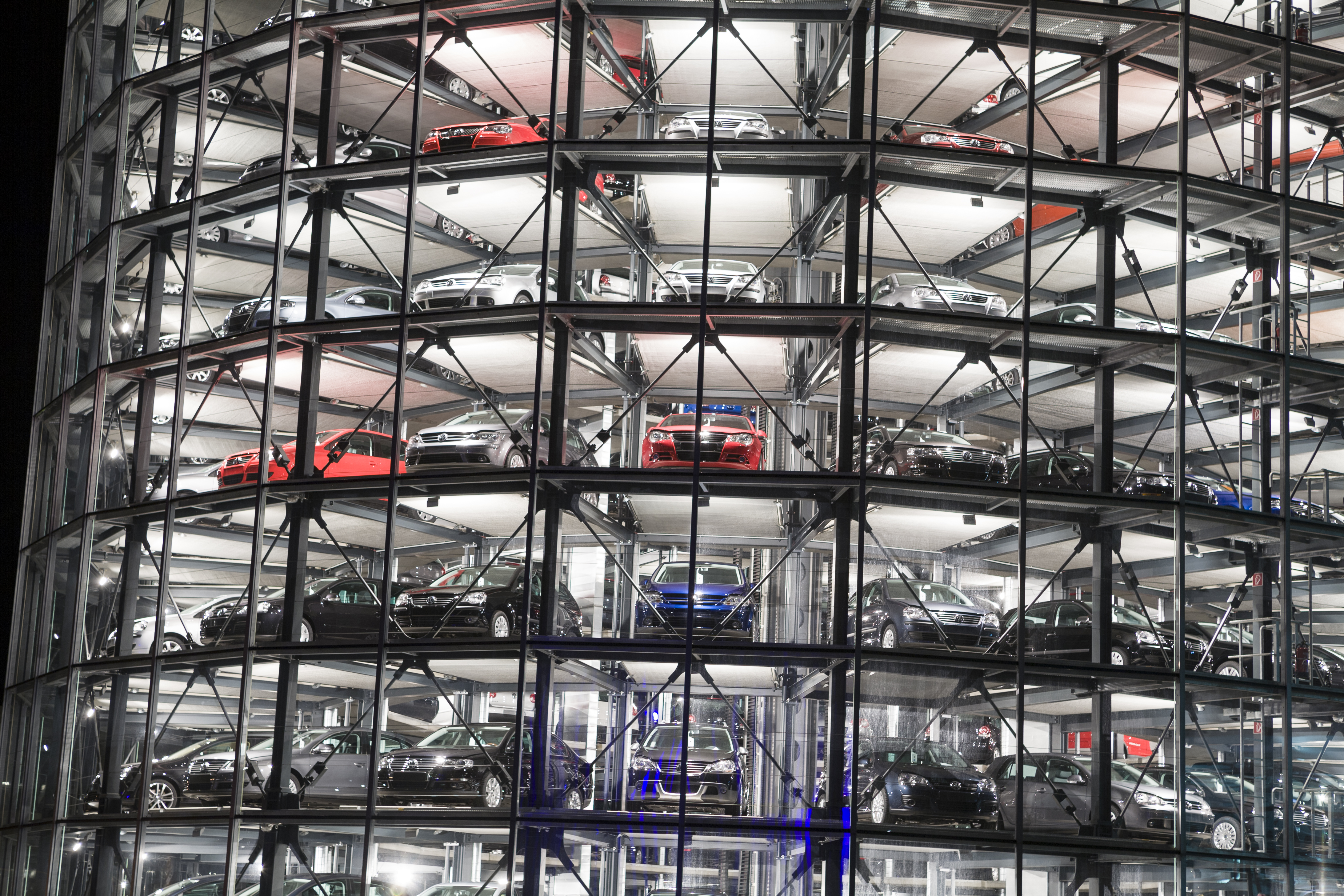 a car parking lot with many cars in a building