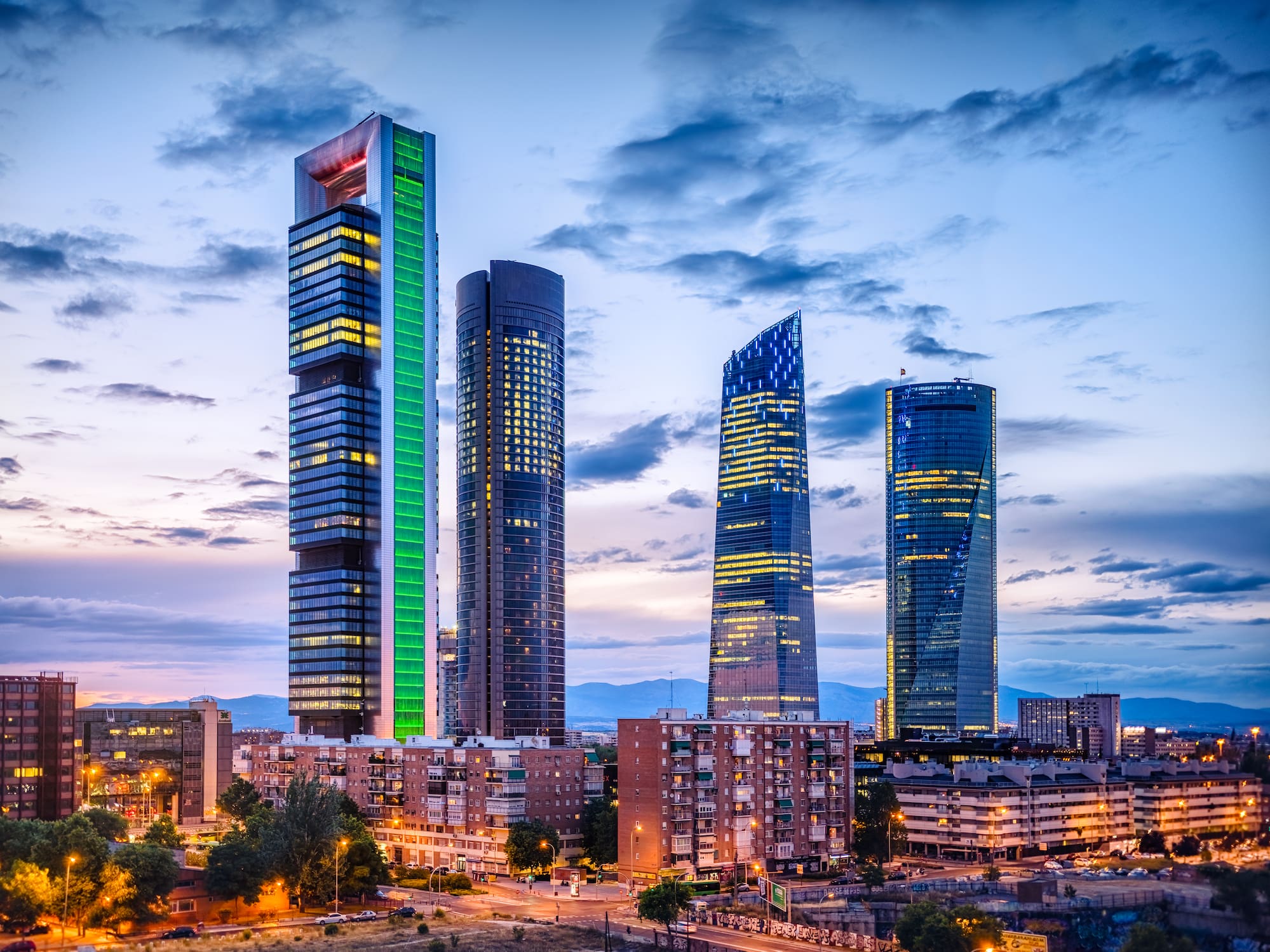 a group of tall buildings with lights