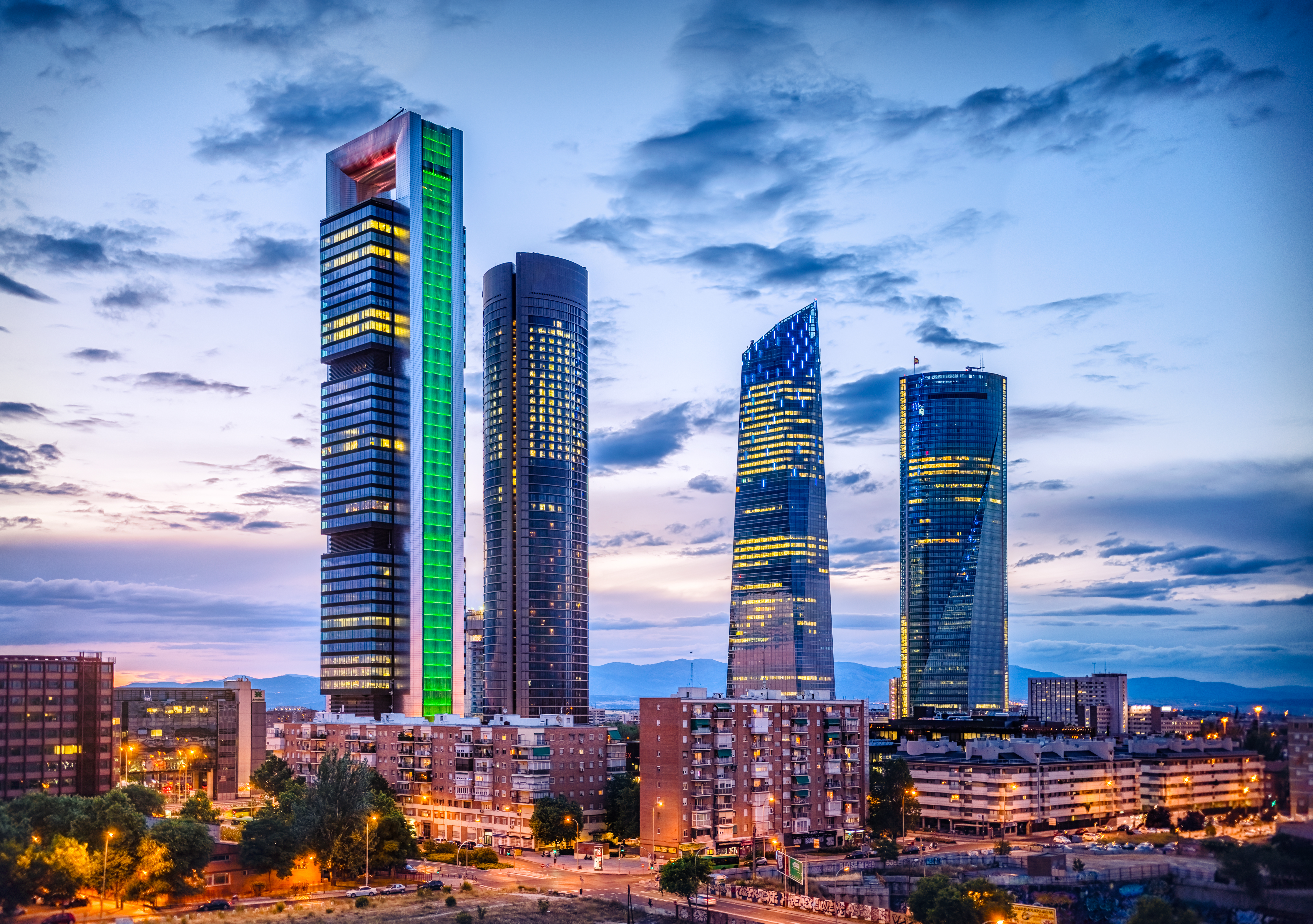 Madrid Four Towers Business Area skyscrapers at twilight, urban cityscape.