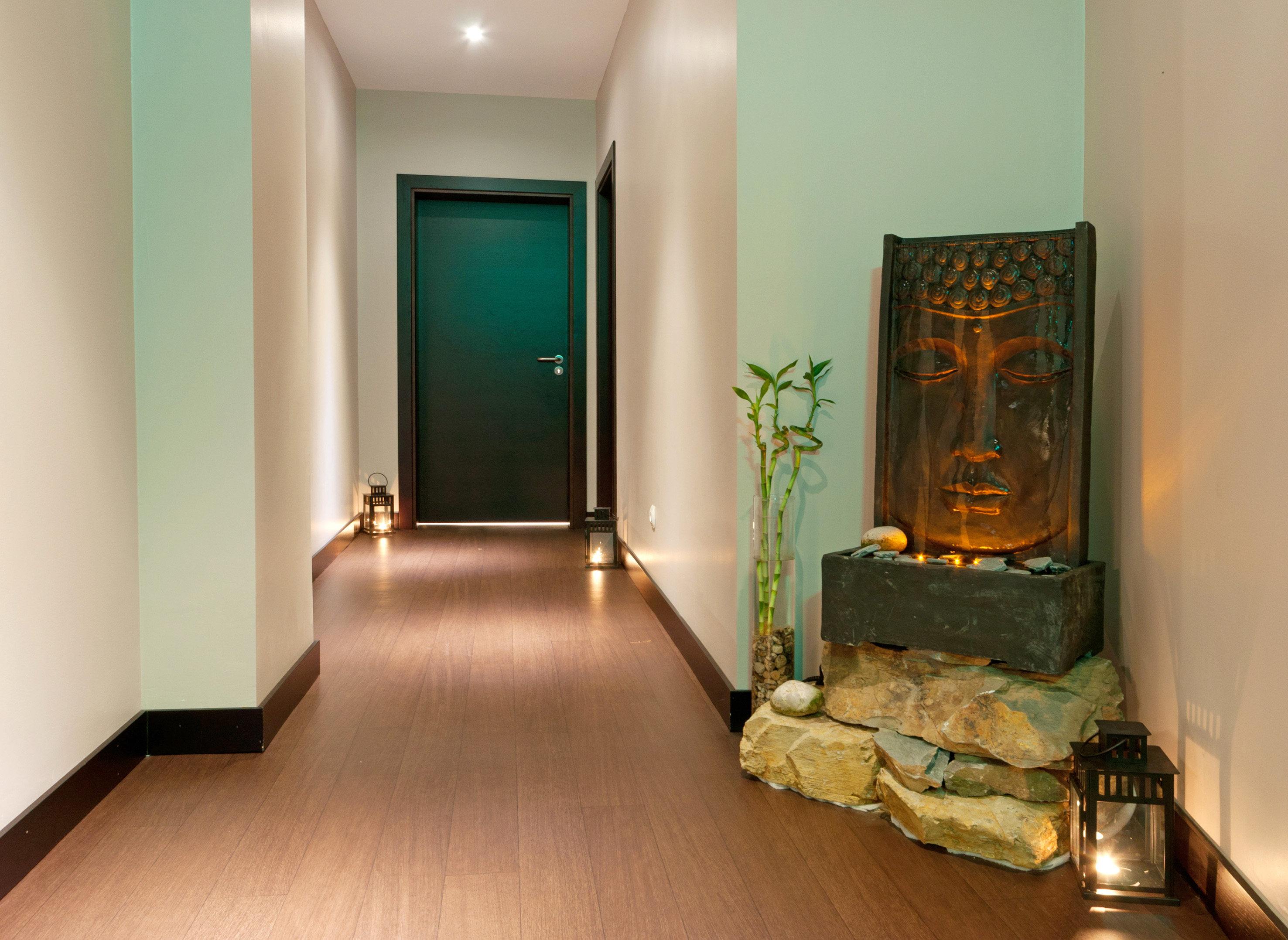 a hallway with a statue and a door