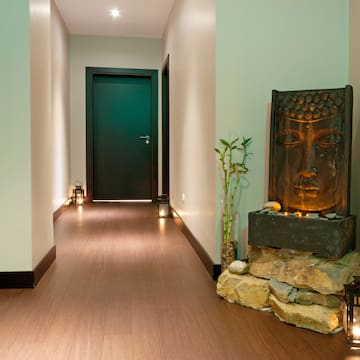 a hallway with a statue and a door
