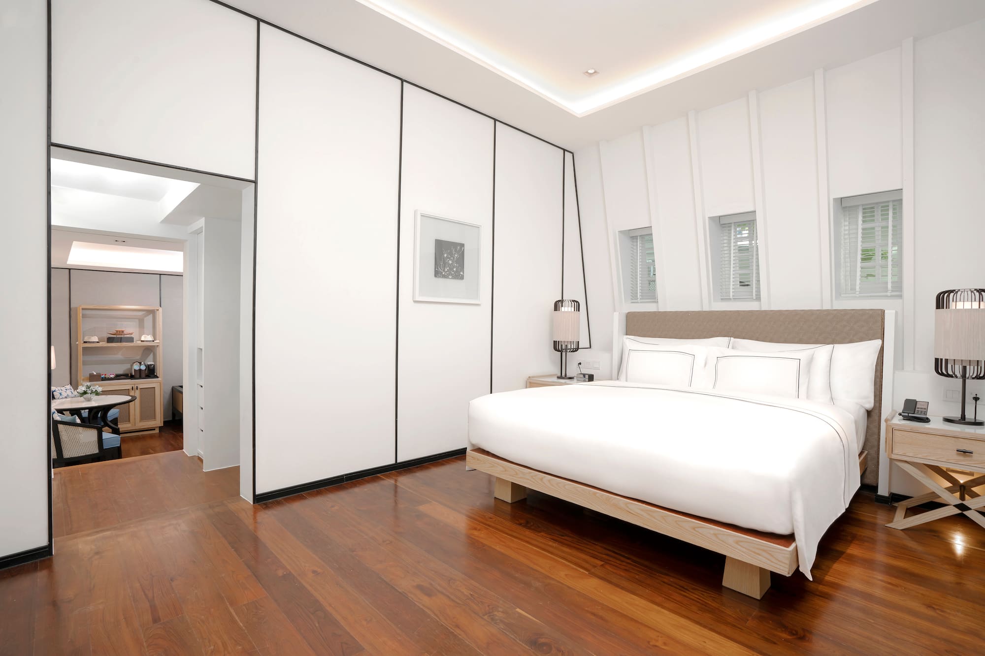 a bedroom with a wood floor and a bed