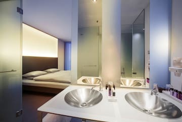 a bathroom with double sink and mirror