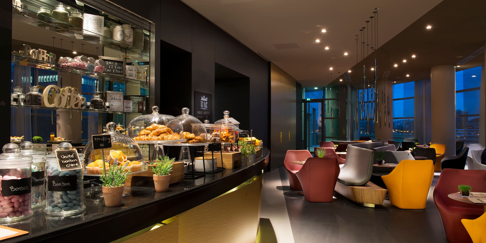 a restaurant with a counter and chairs