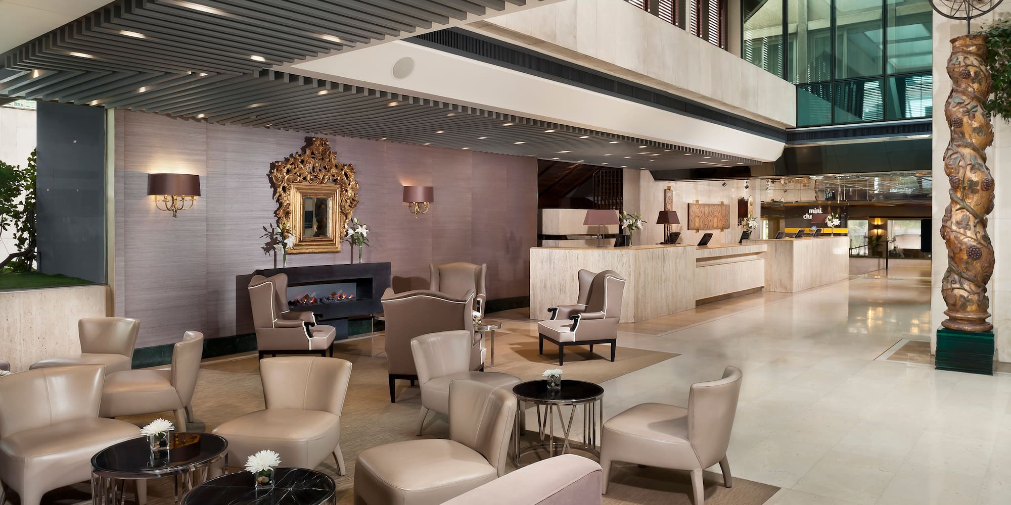 a lobby with a large reception desk and chairs