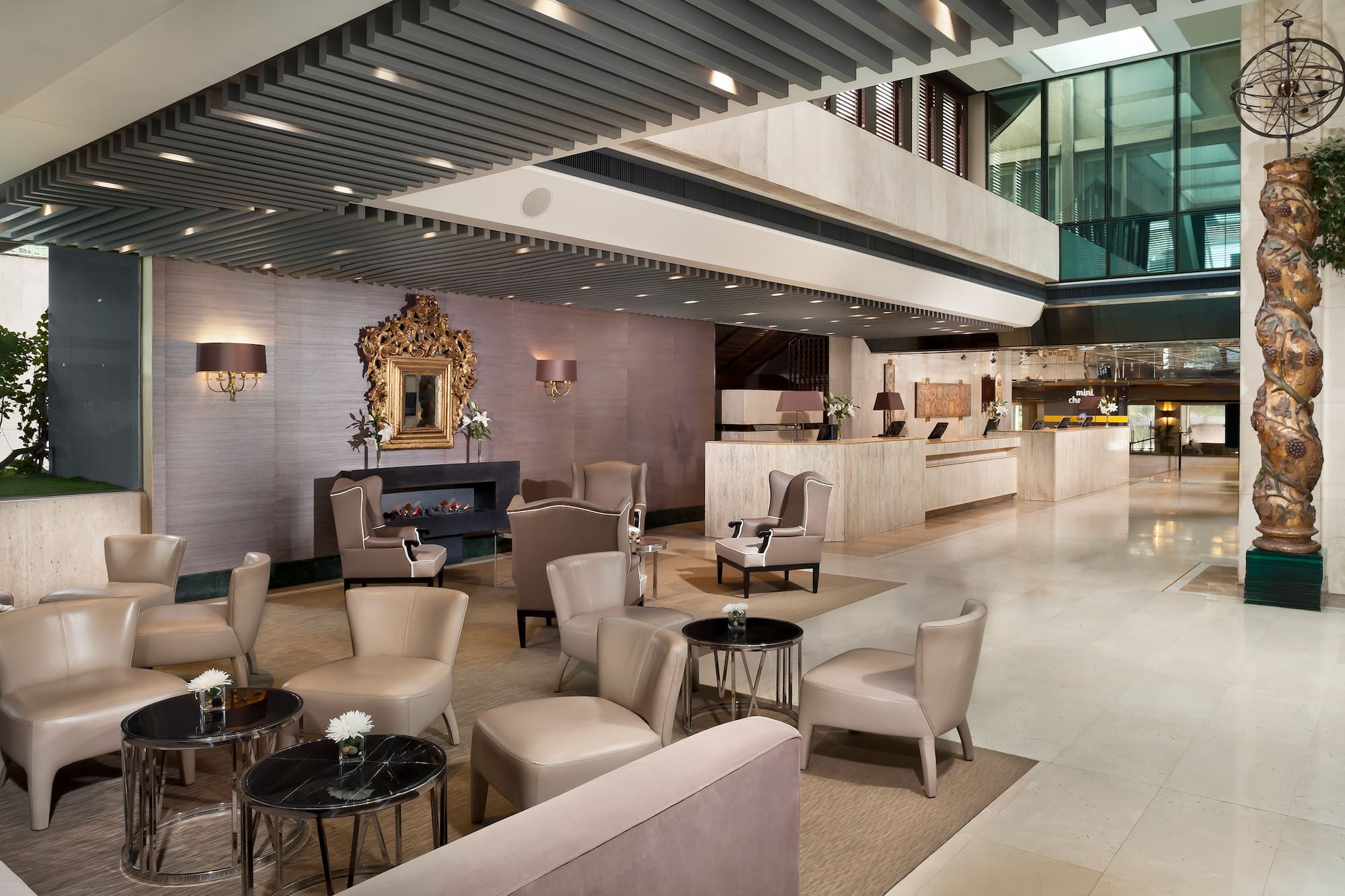 Luxurious hotel lounge with elegant seating, fireplace, and front desk.