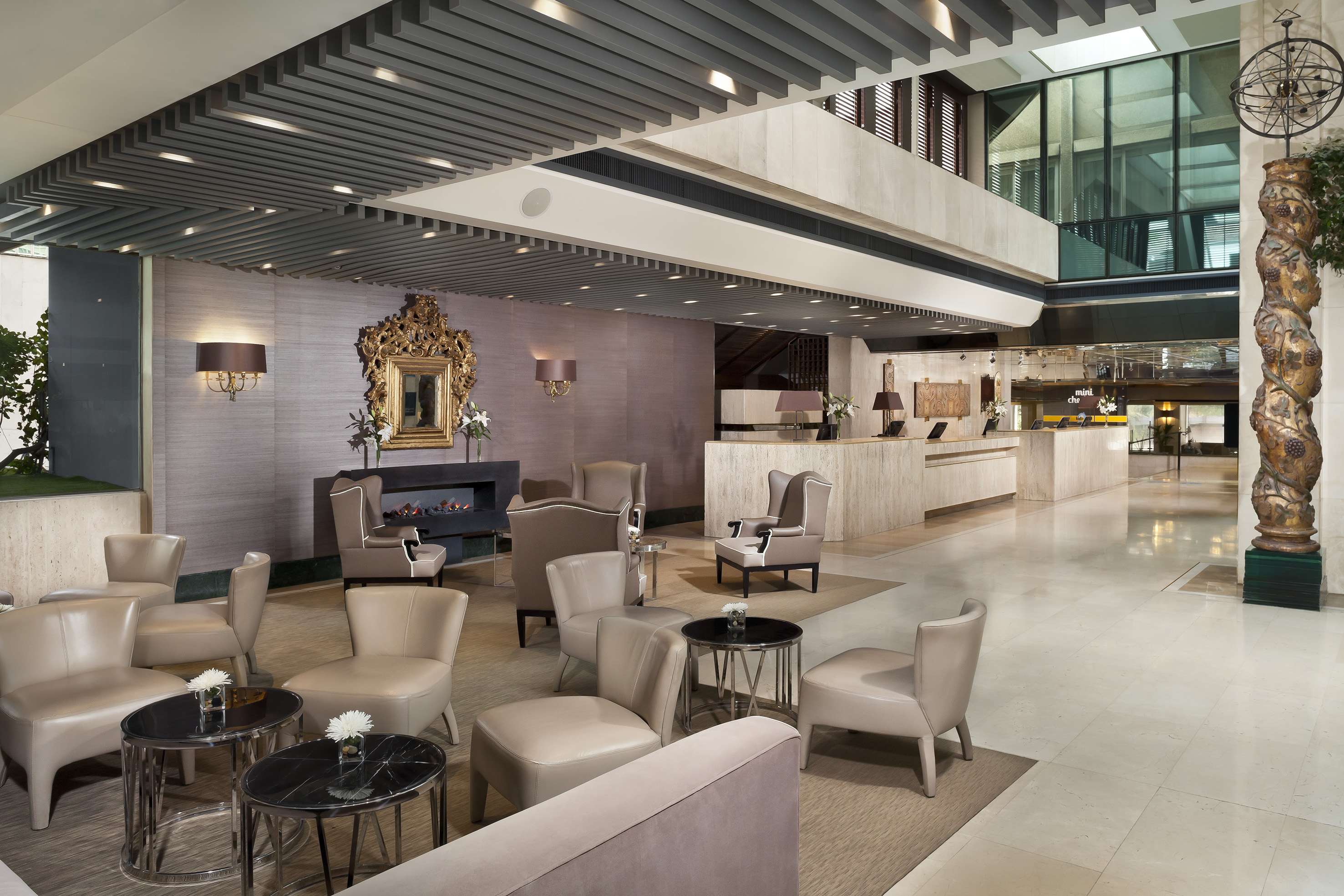 Luxurious hotel lounge with elegant seating, fireplace, and front desk.