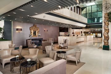 a lobby with a large reception desk and chairs