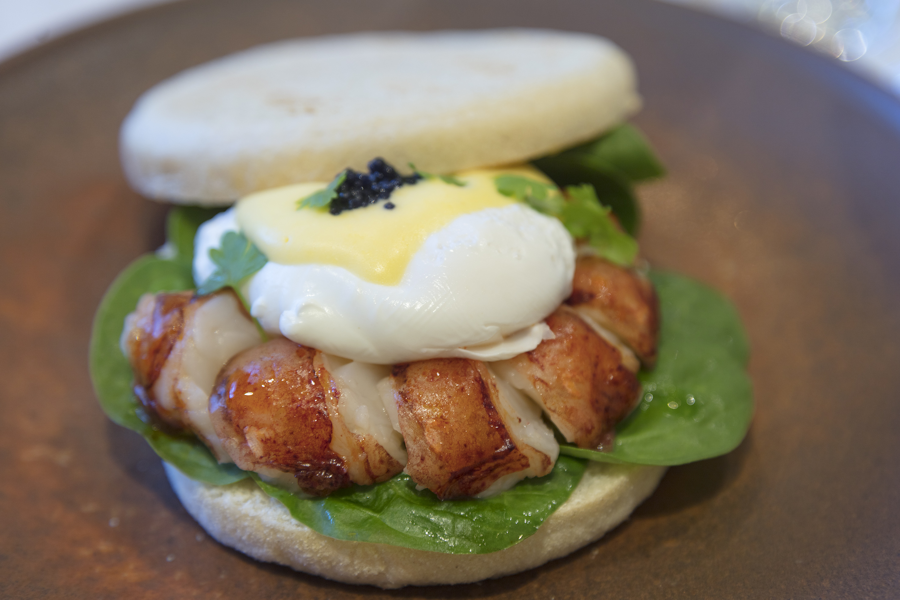 a sandwich with bacon and eggs on top