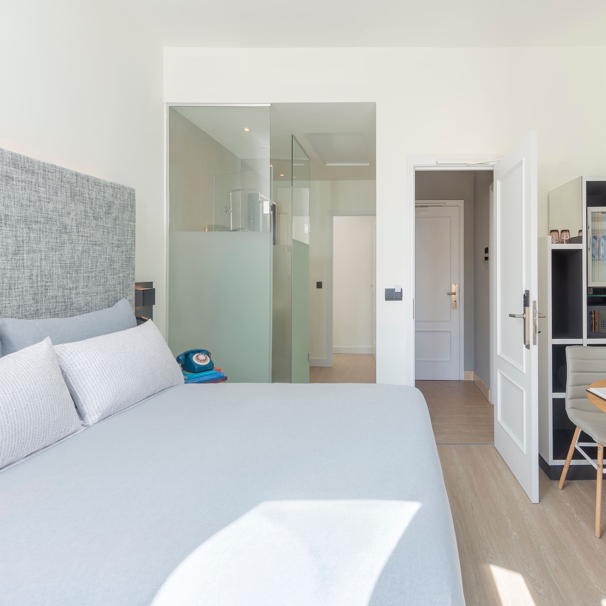 a bedroom with a bed and a desk