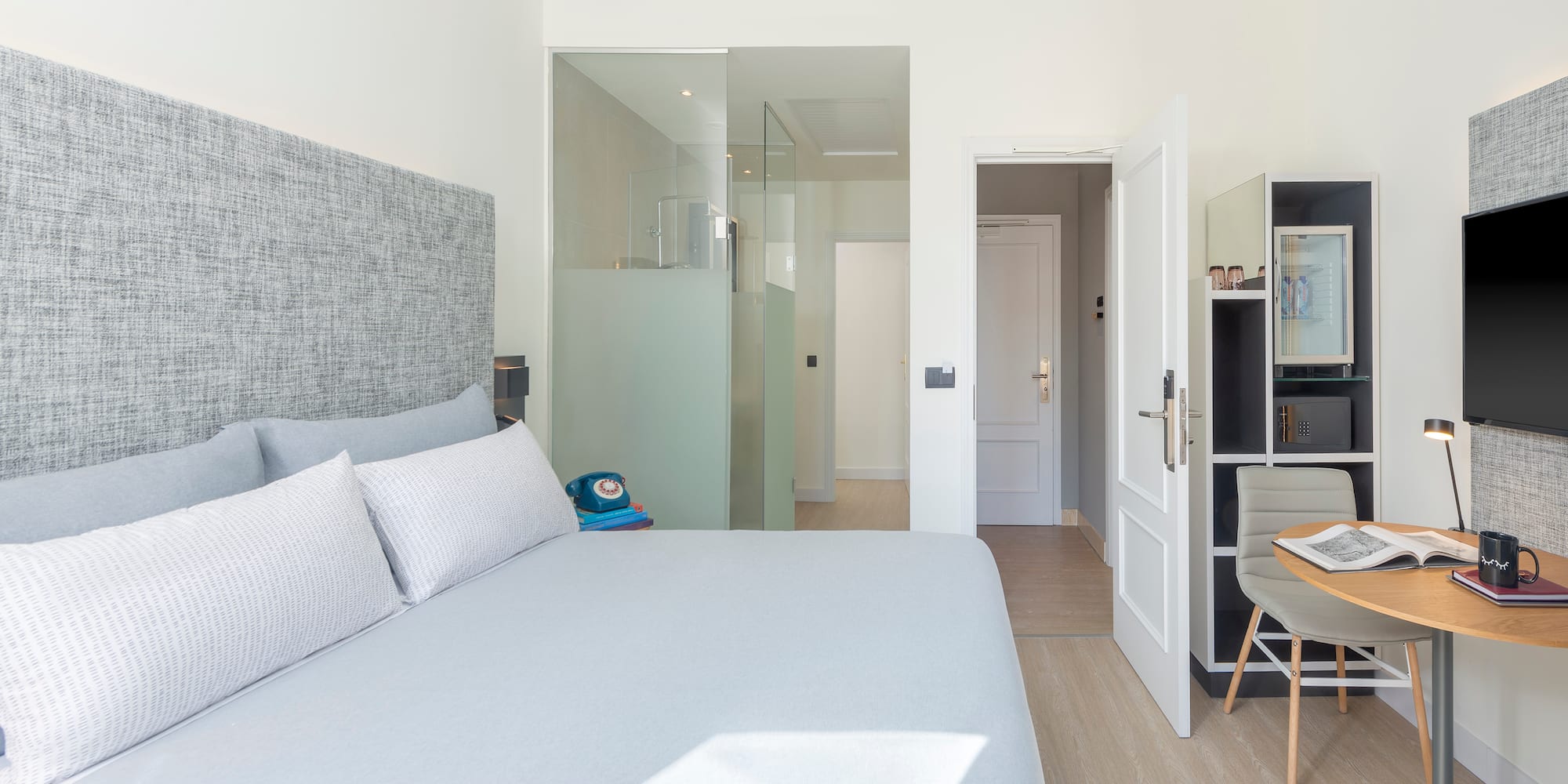 a bedroom with a bed and a desk