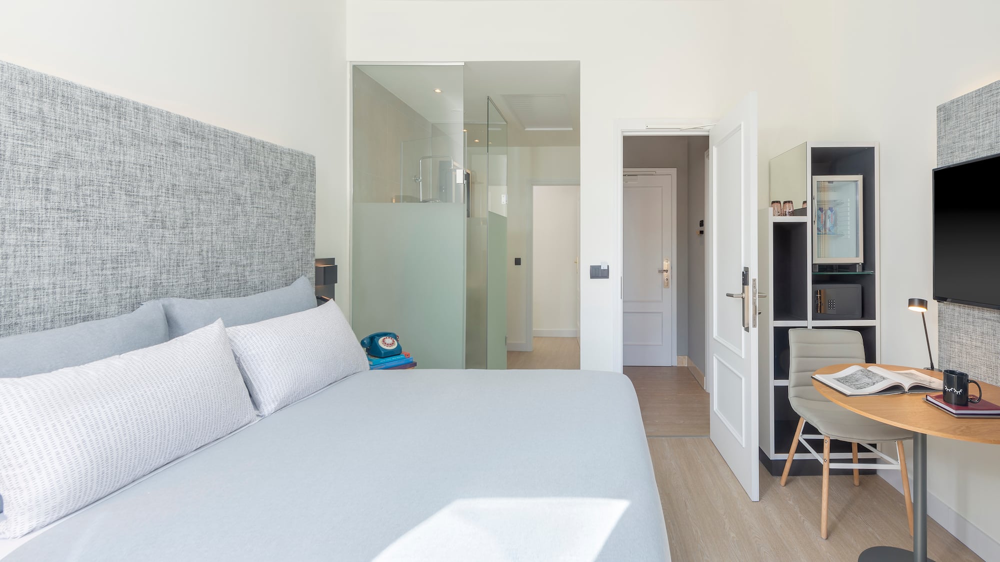 a bedroom with a bed and a desk