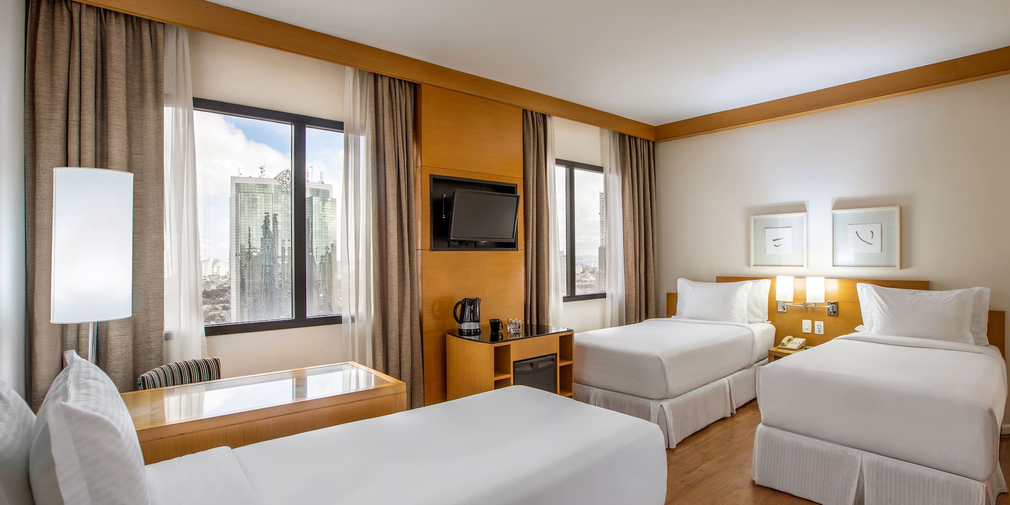 a room with two beds and a television