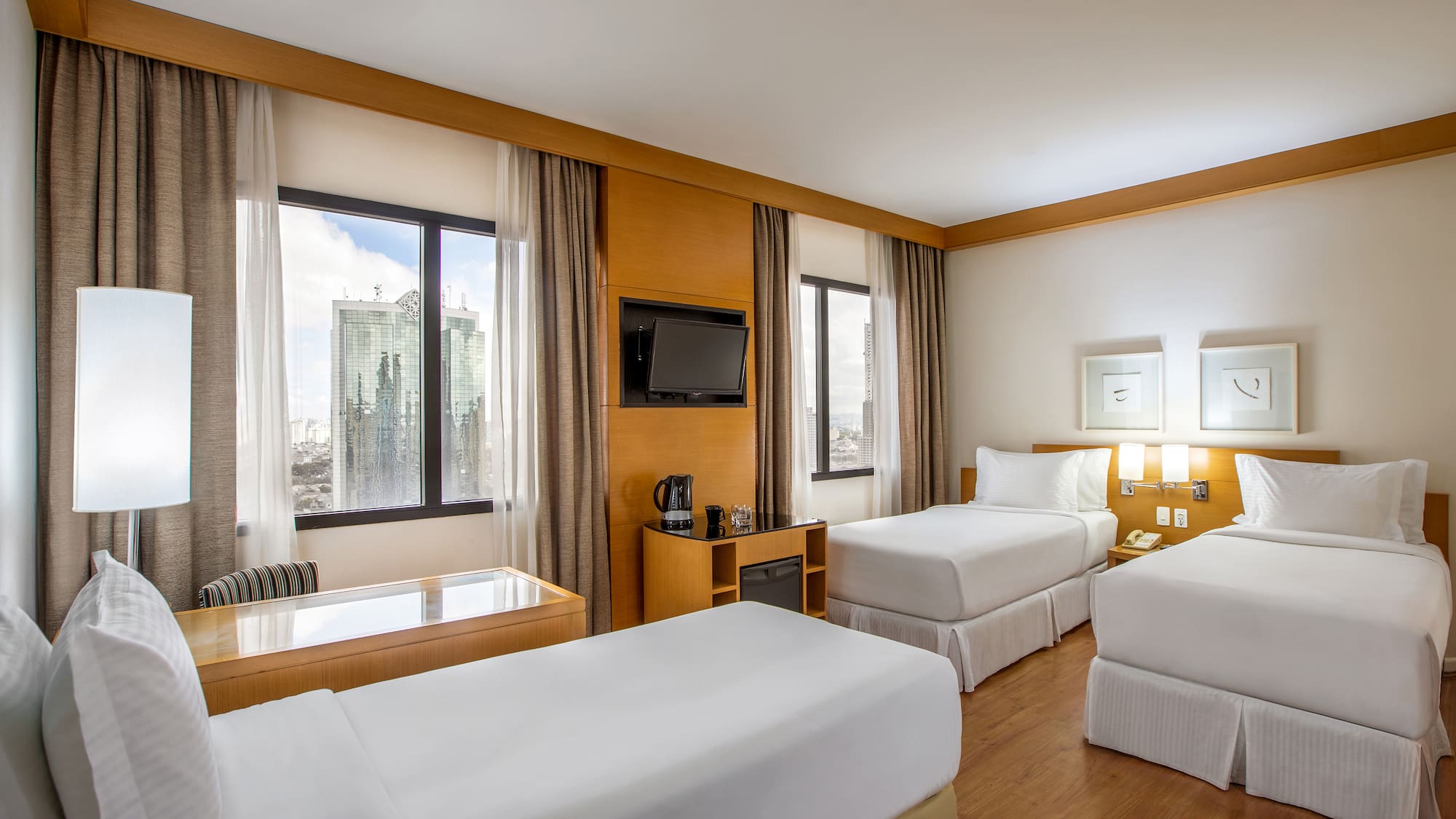 a room with two beds and a television