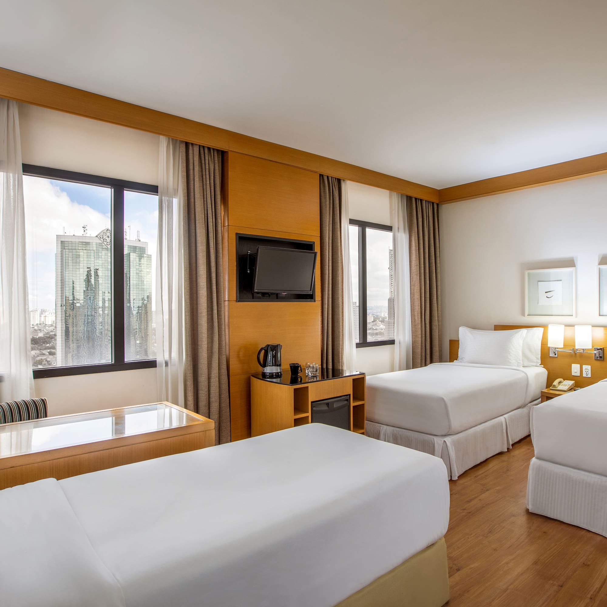 a room with two beds and a television