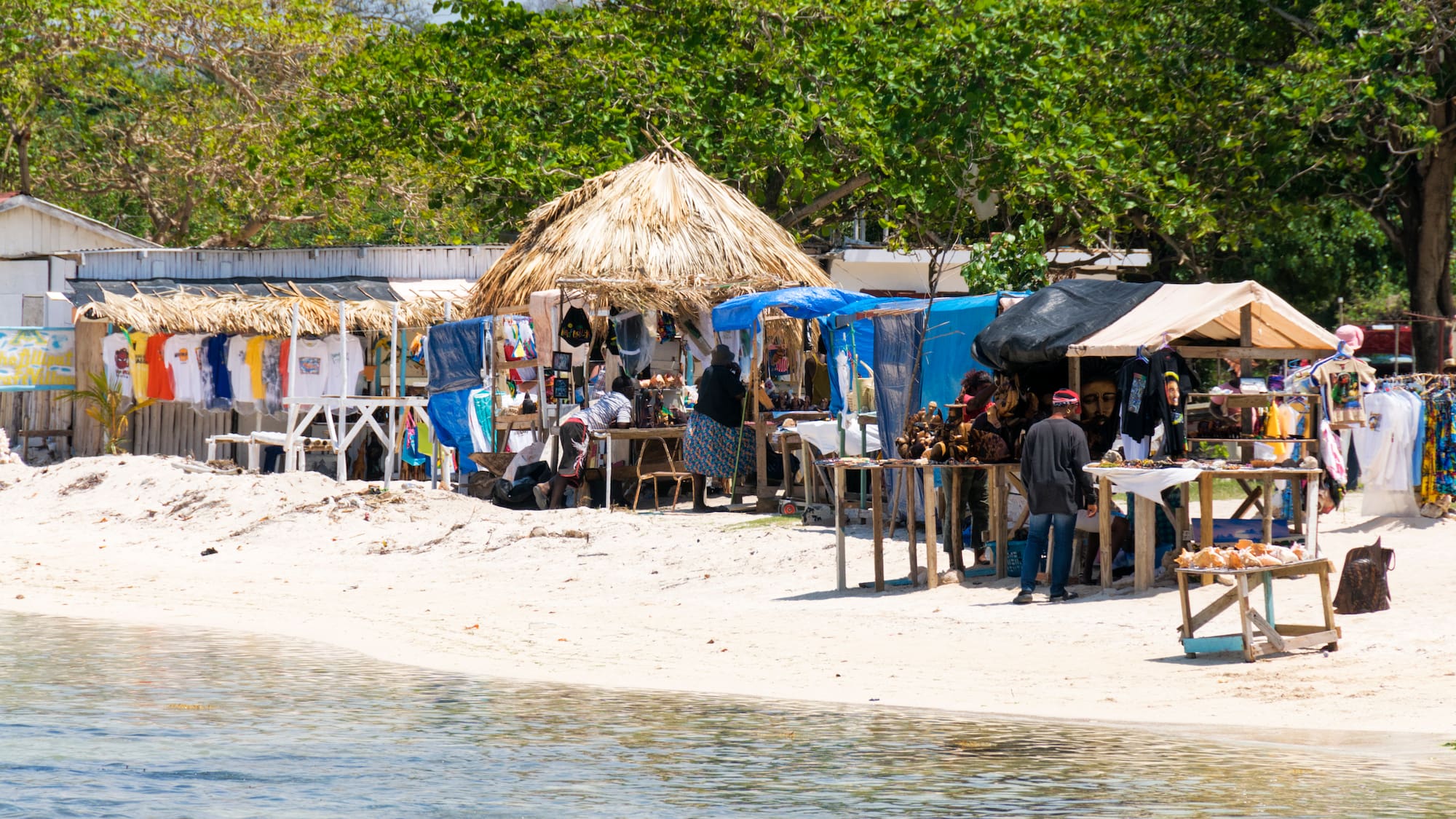 a beach with tents and people on it