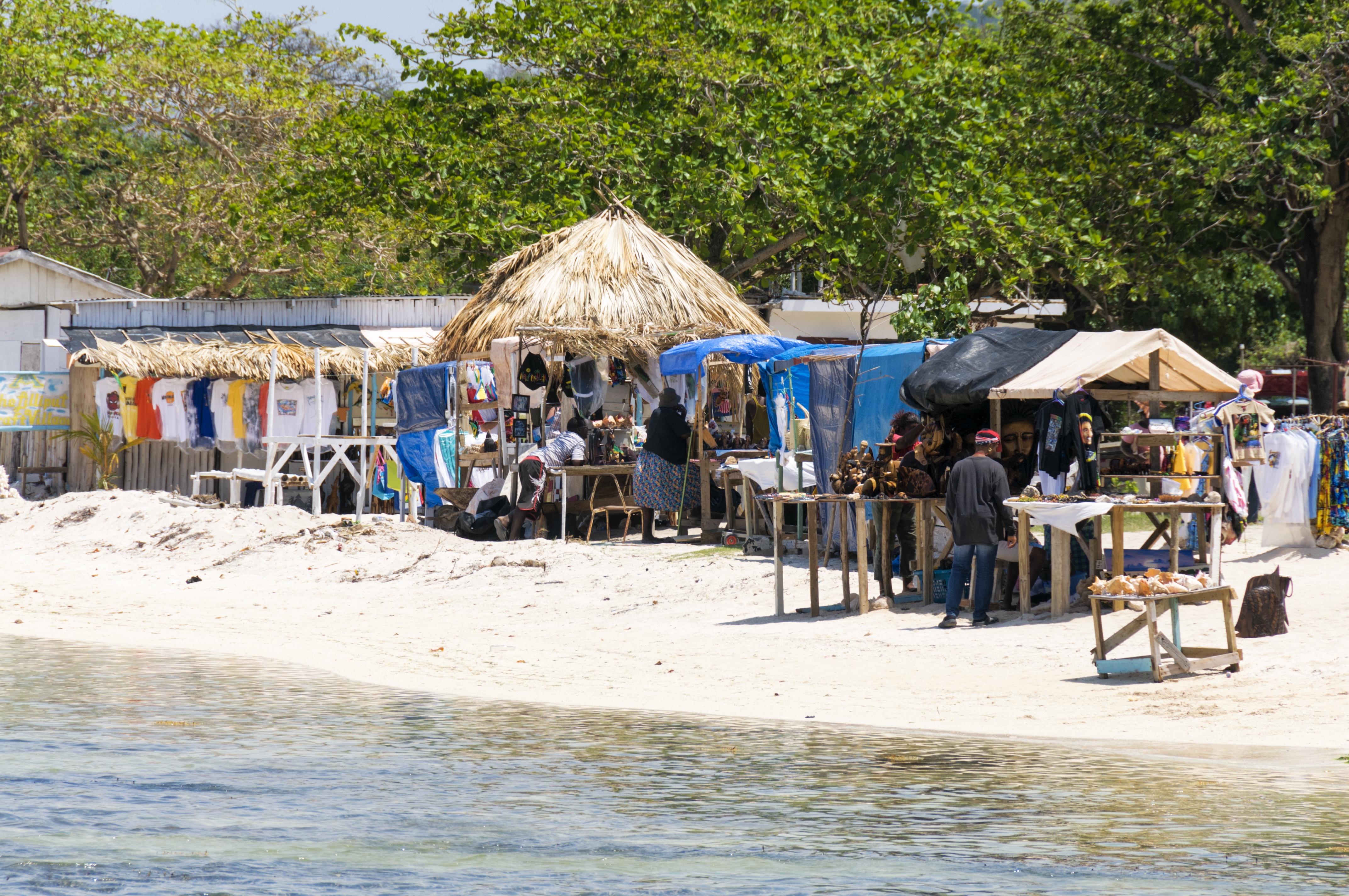 a beach with tents and people on it