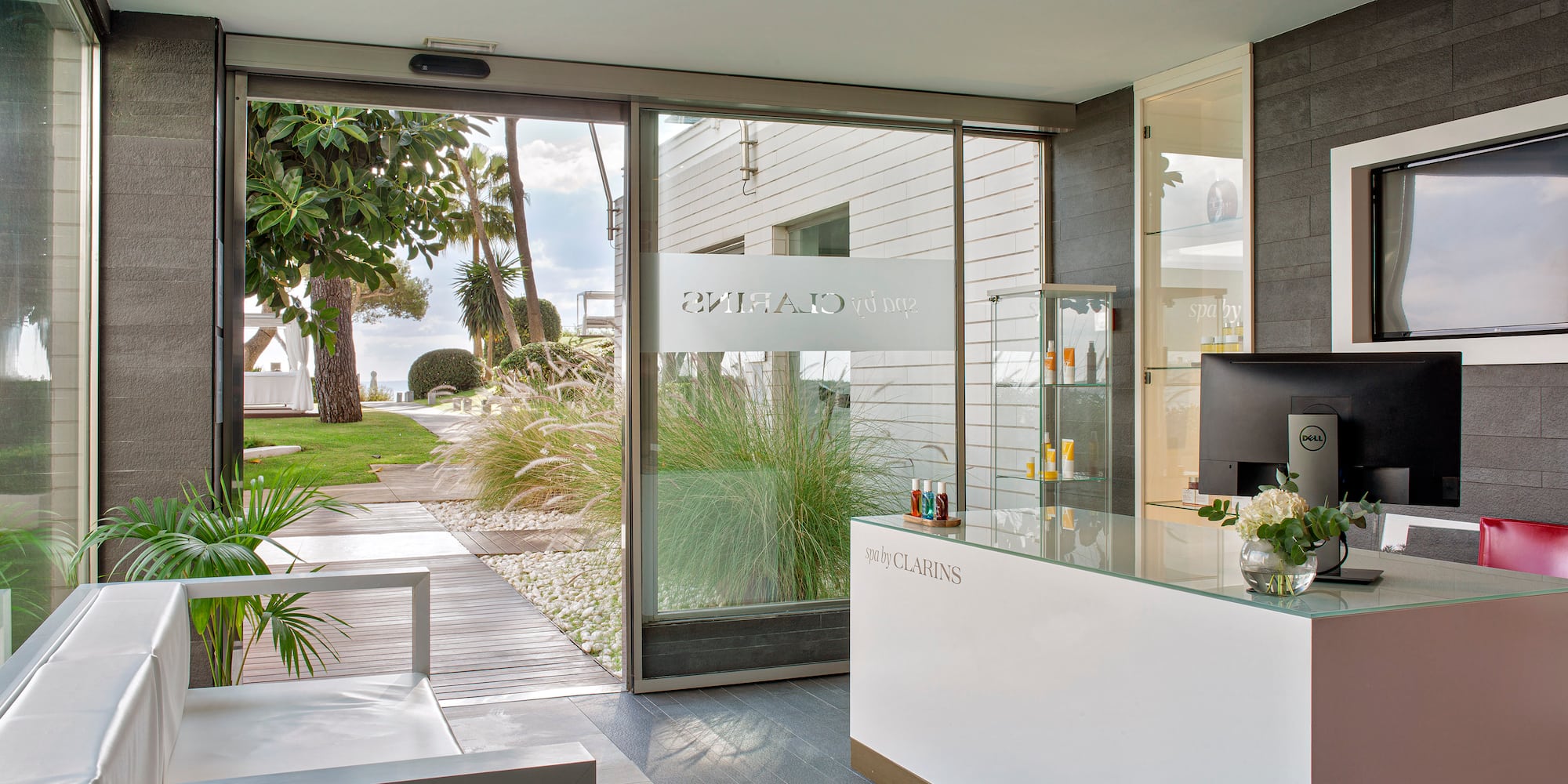 a reception desk in a room with glass doors