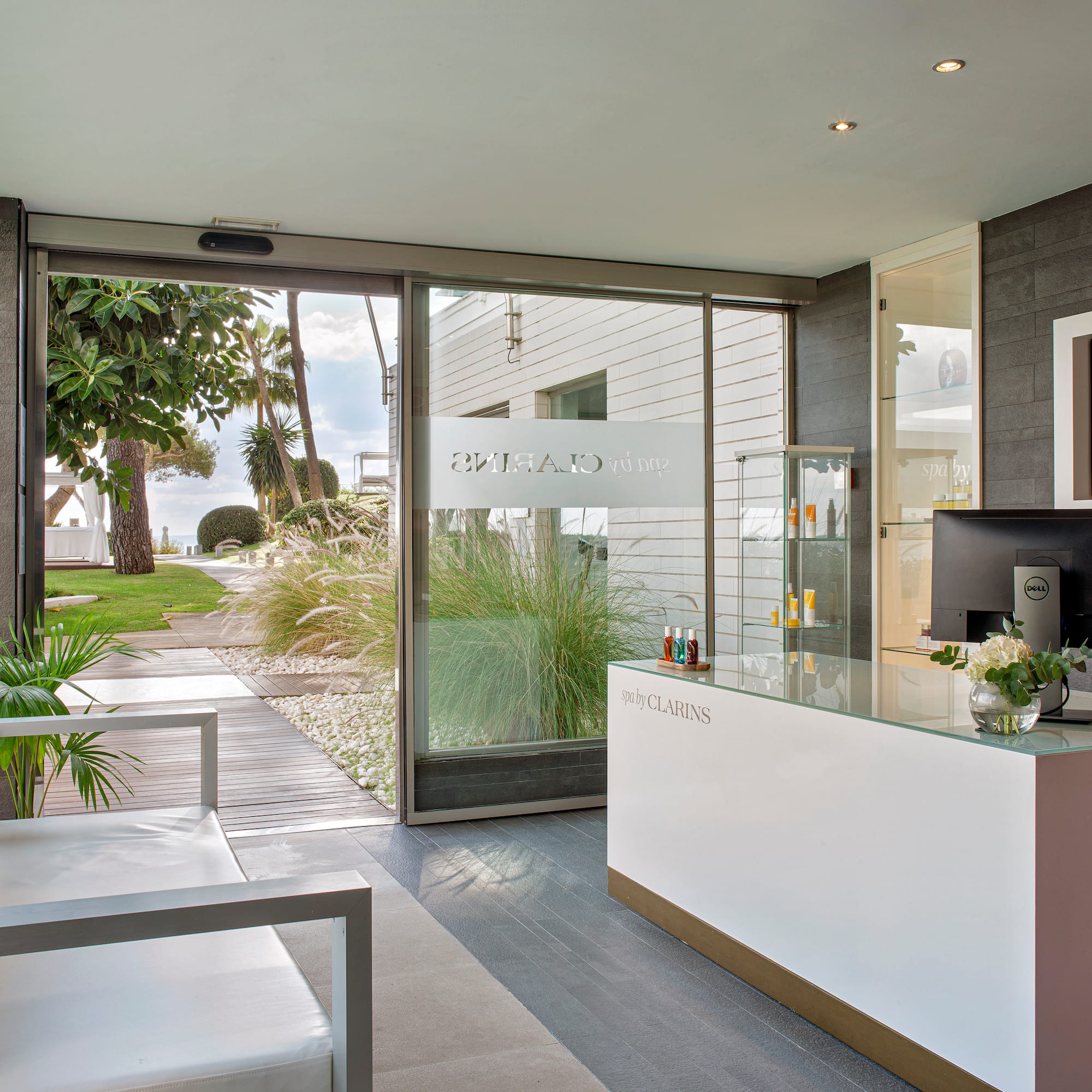 a reception desk in a room with glass doors
