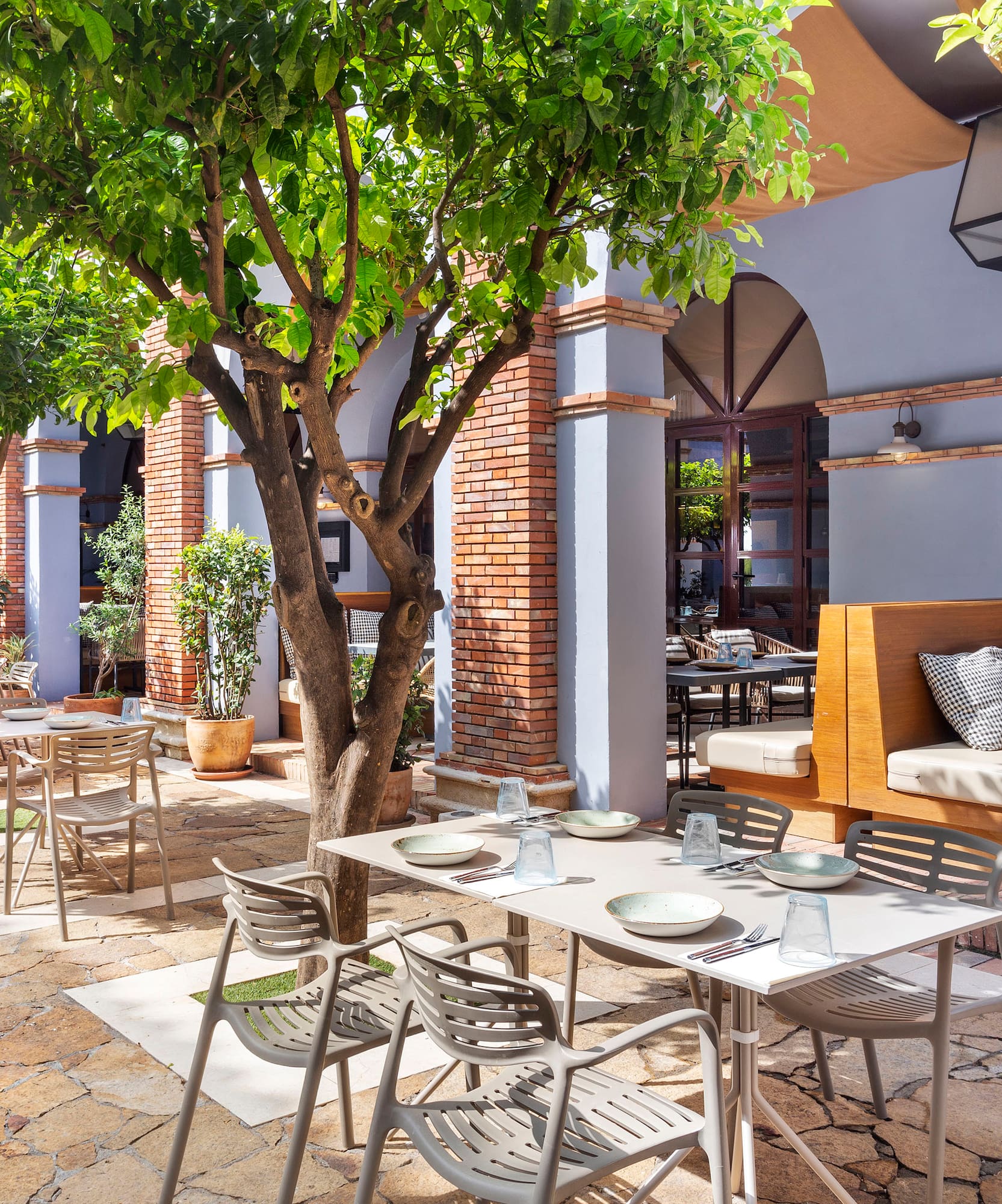 a patio with tables and chairs