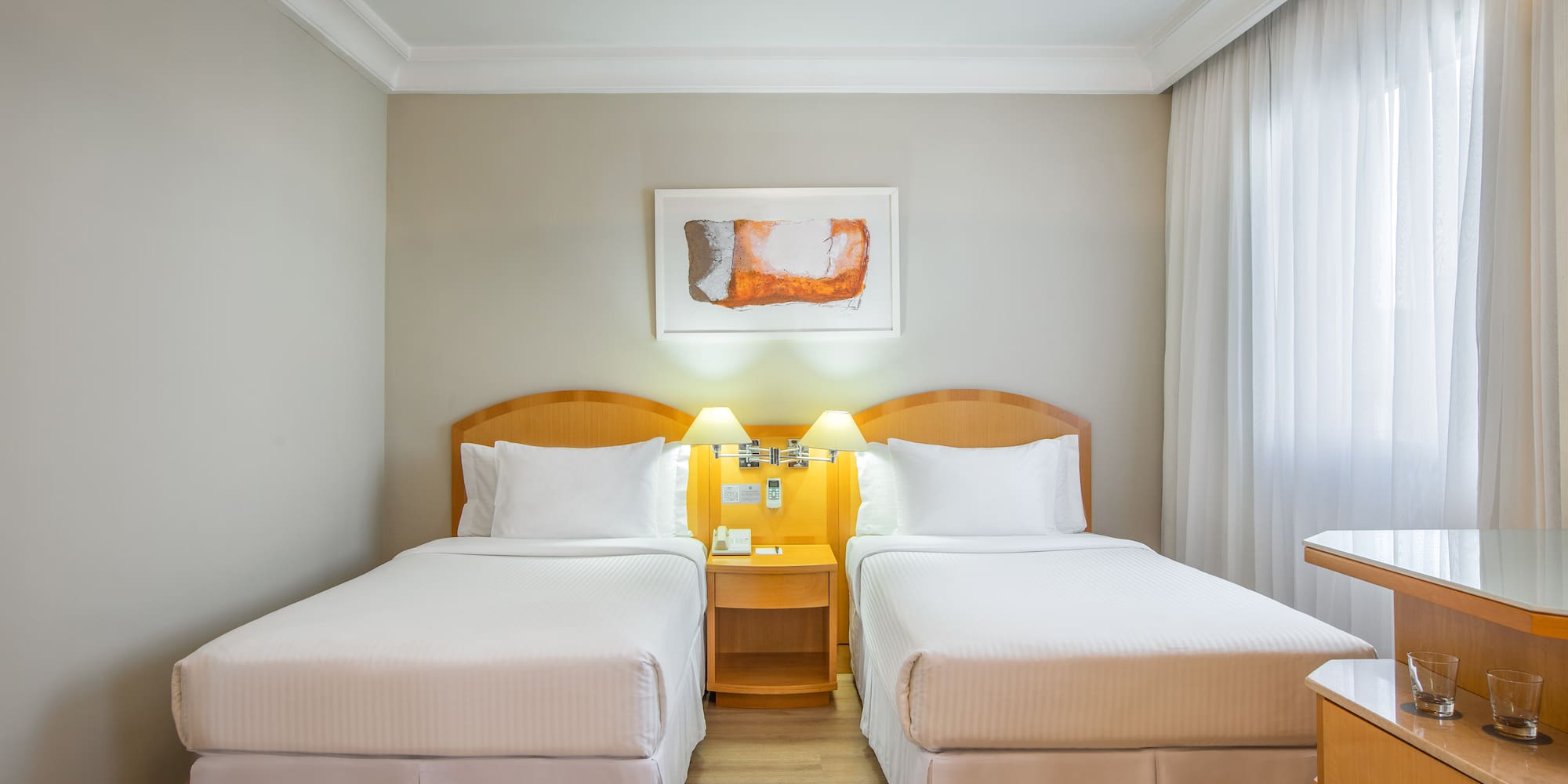 a room with two beds and a table