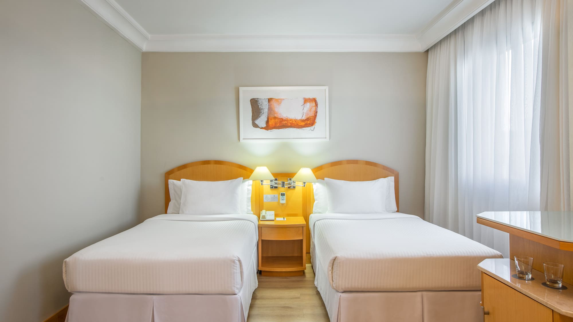 a room with two beds and a table