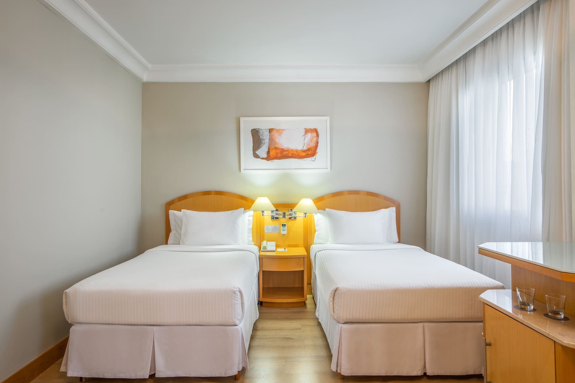 a room with two beds and a table