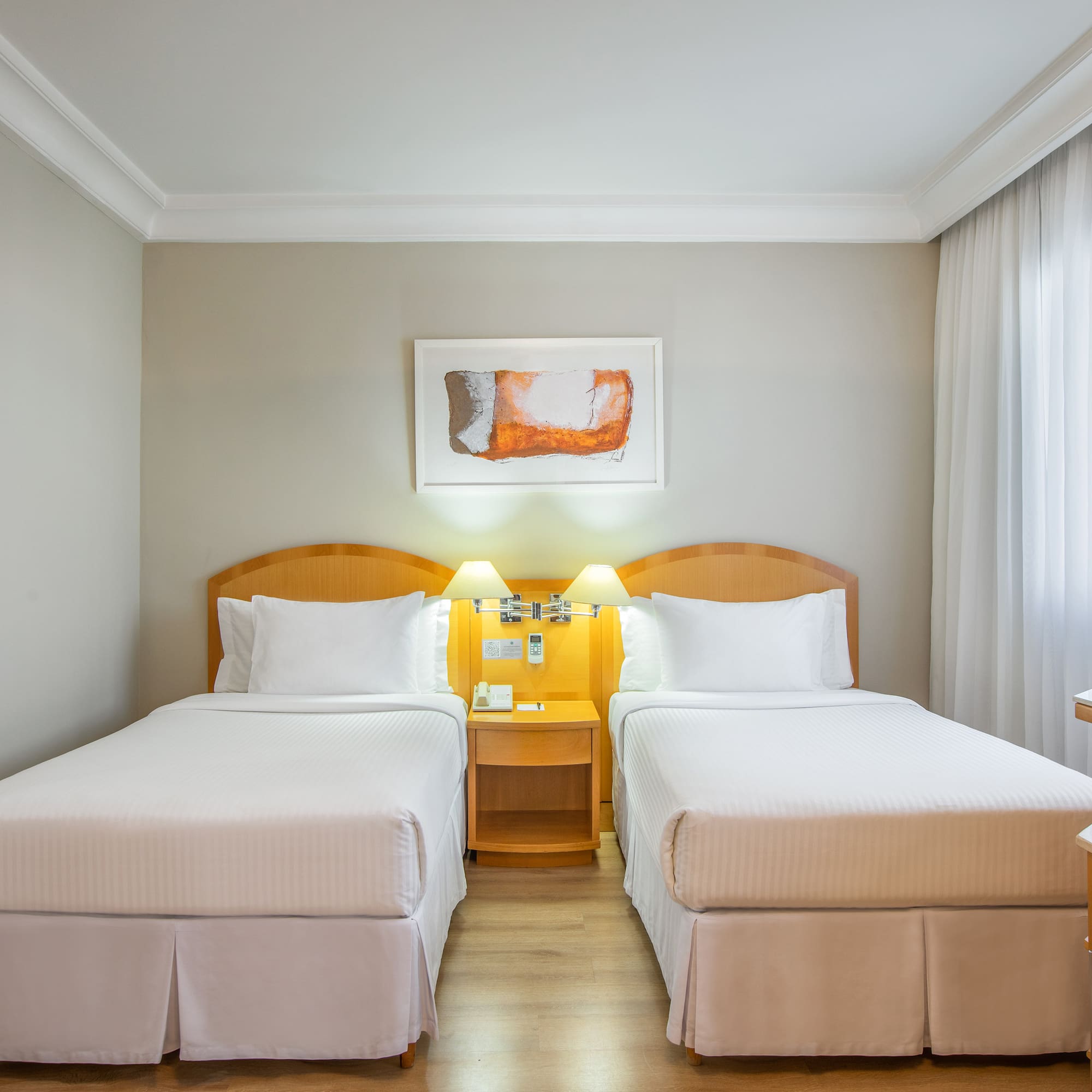 a room with two beds and a table