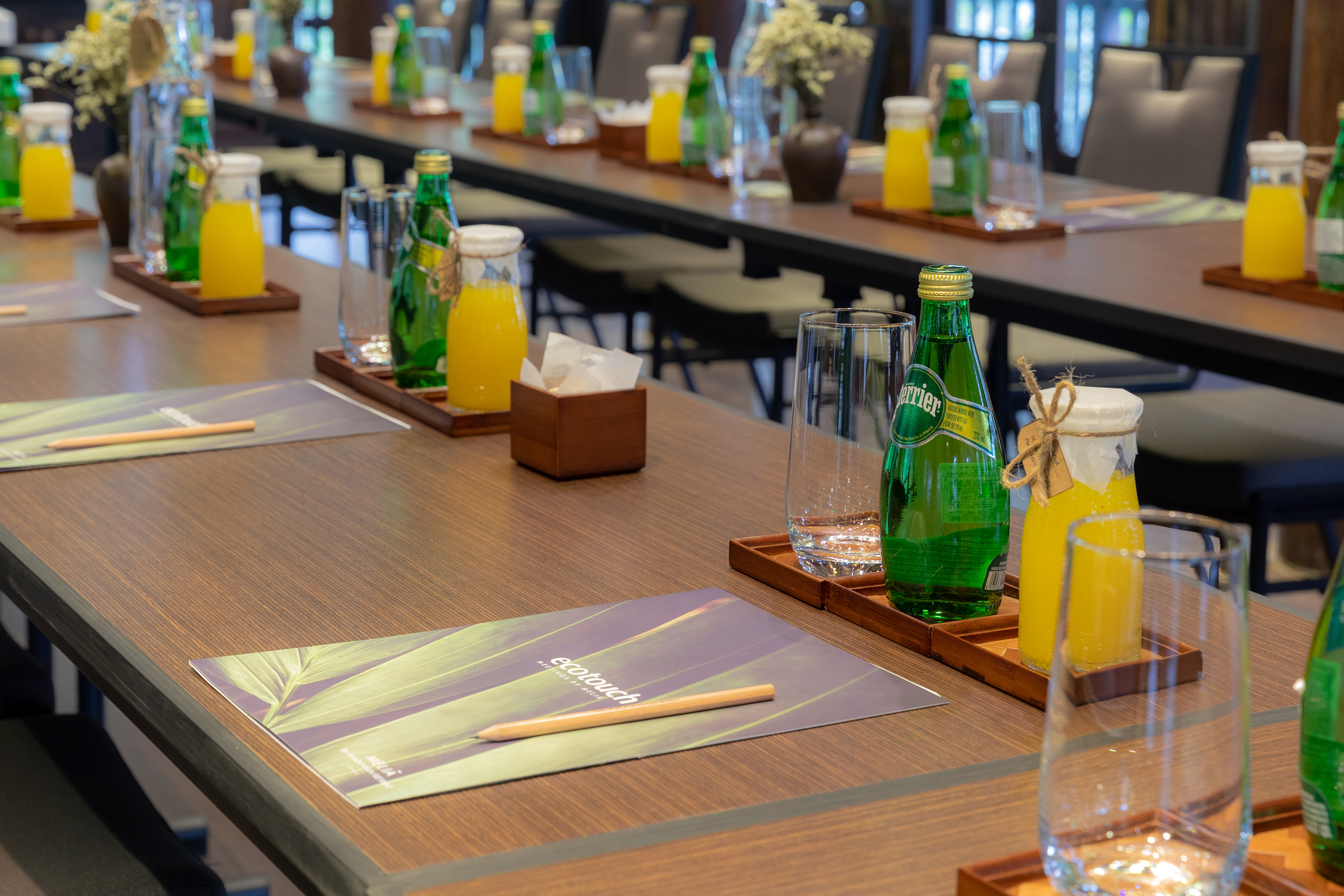 a table with glasses and bottles of juice