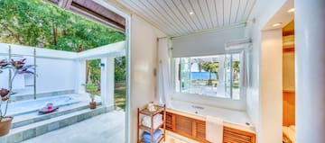 a bathroom with a bathtub and a window