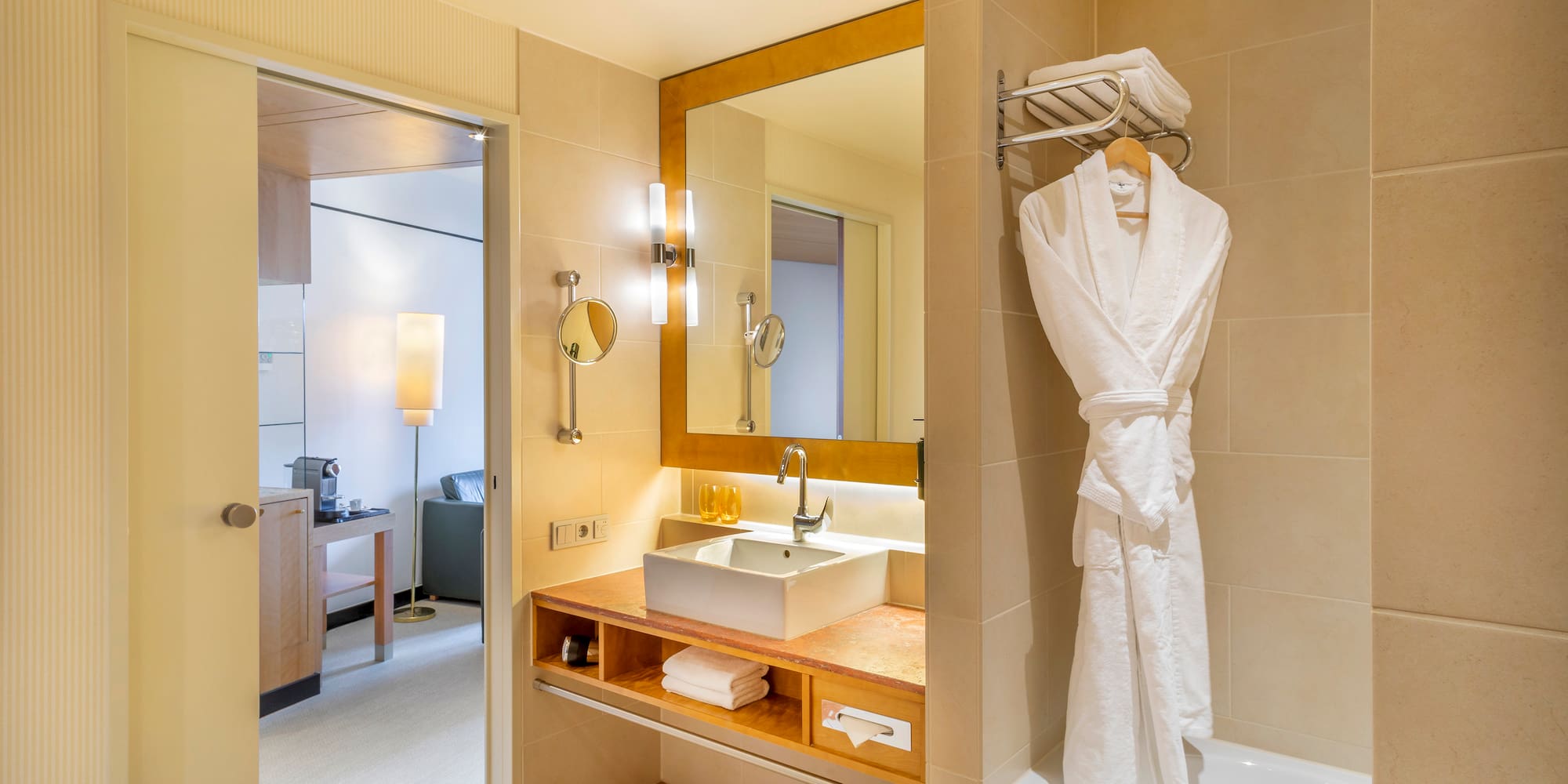 a bathroom with a bathrobe and sink