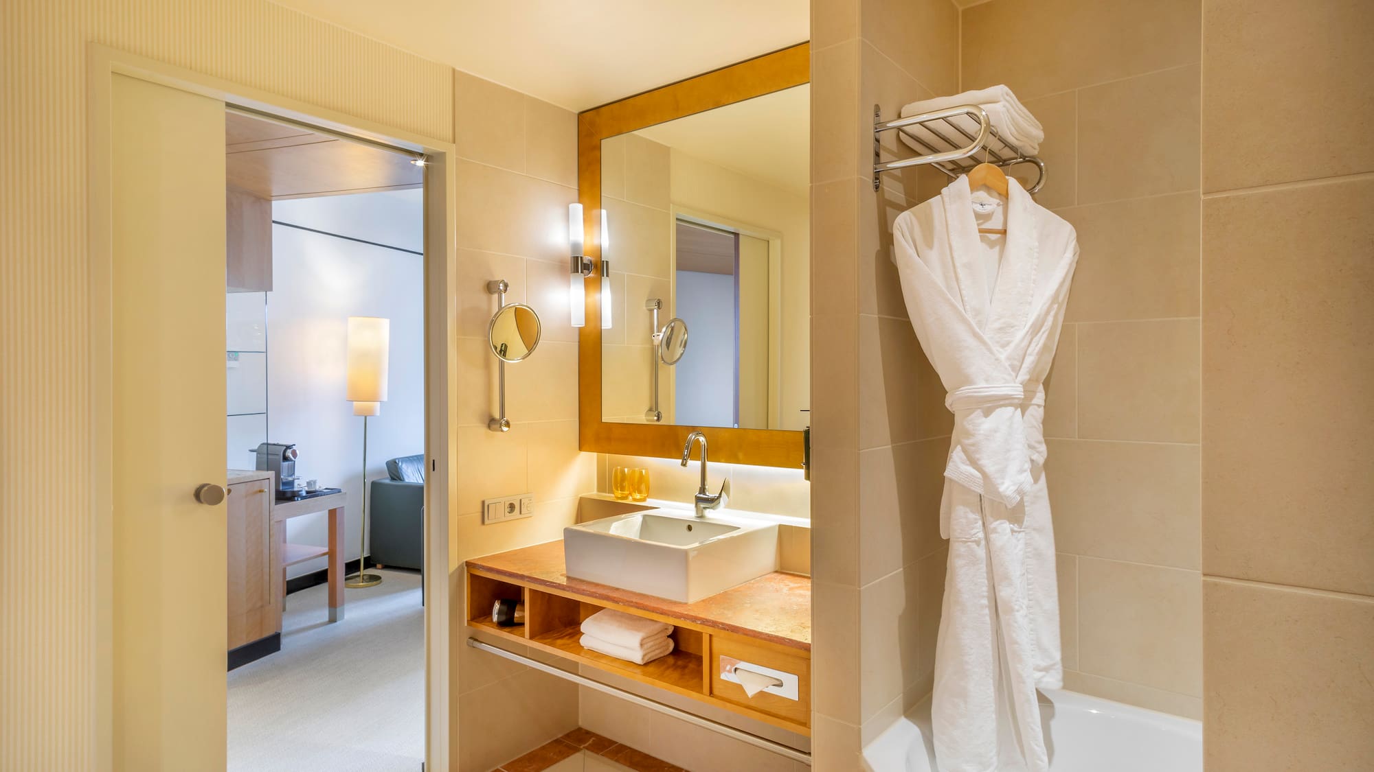 a bathroom with a bathrobe and sink