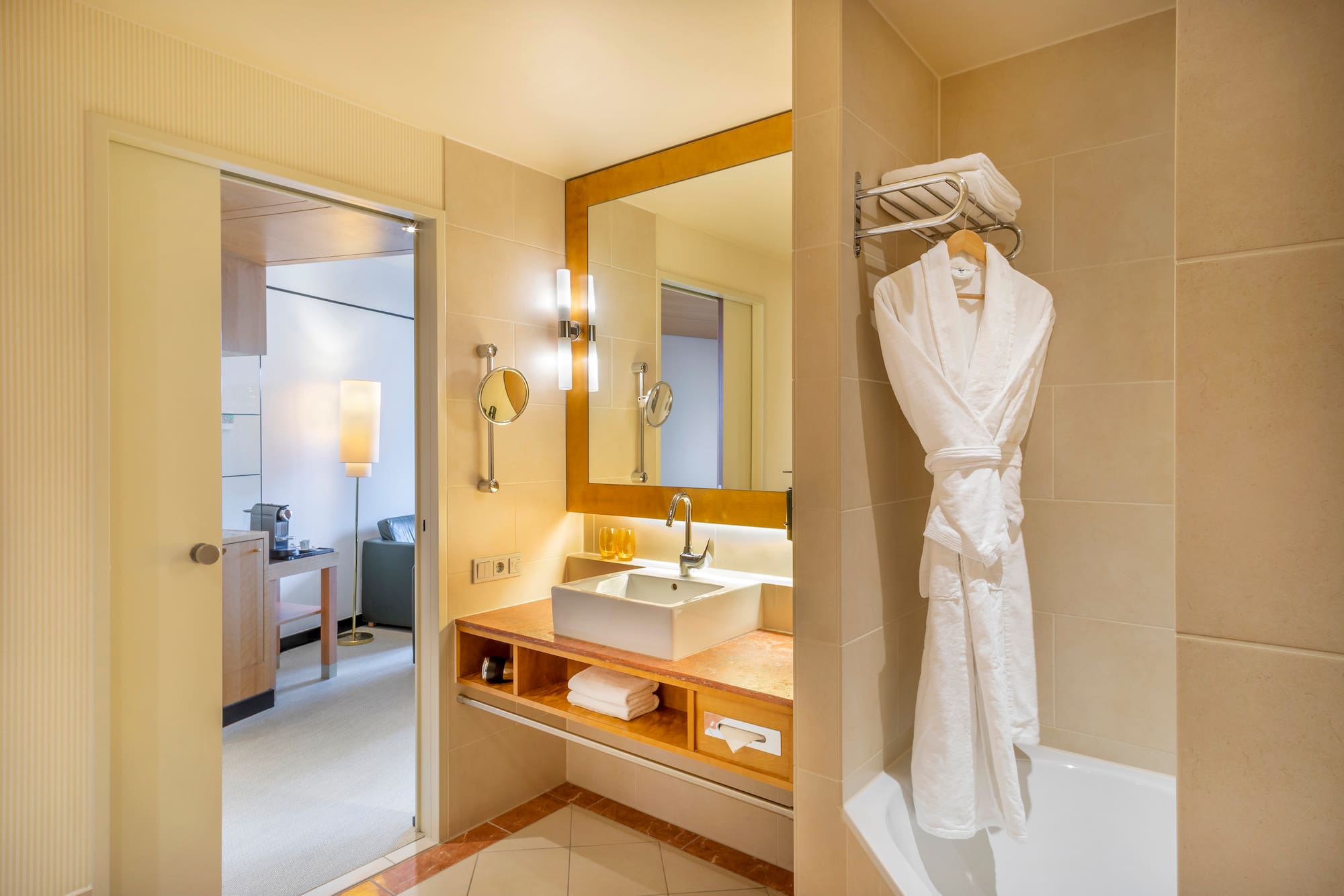 a bathroom with a bathrobe and sink