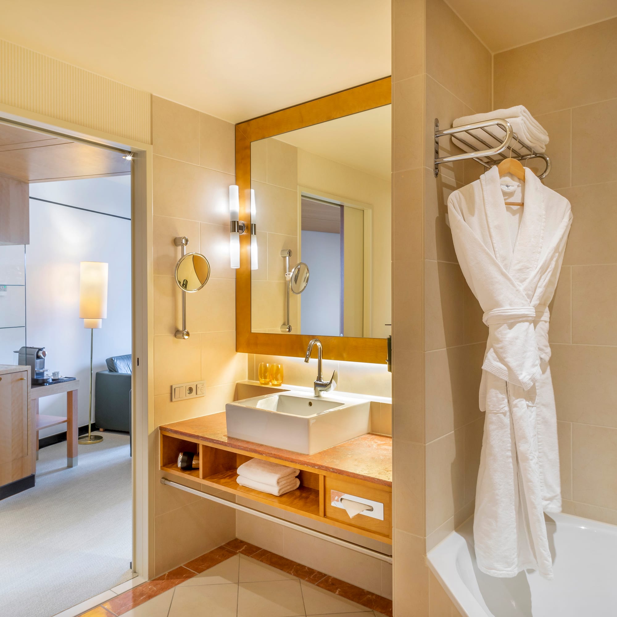 a bathroom with a bathrobe and sink