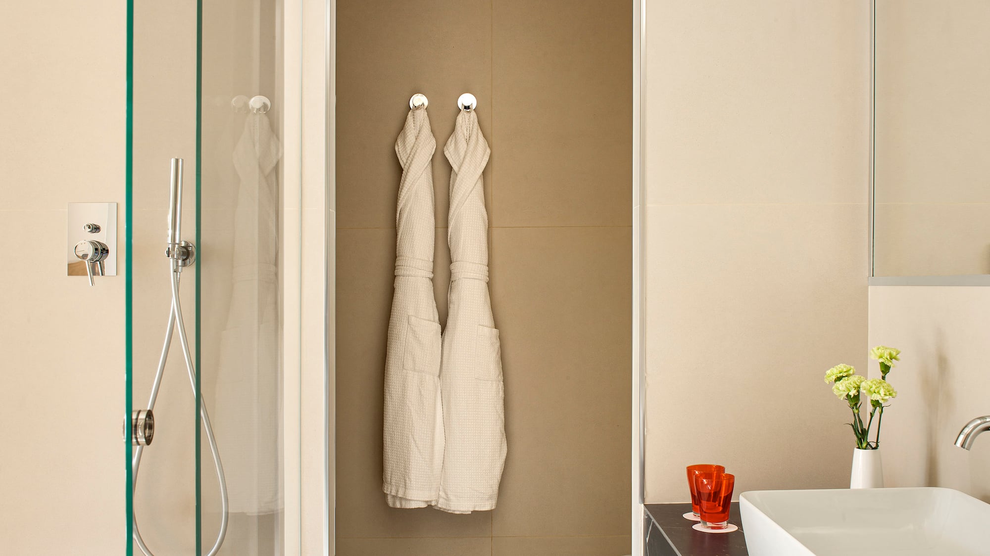 a bathroom with white towels on the wall