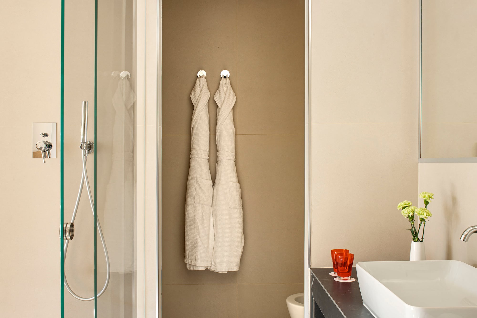 a bathroom with white towels on the wall