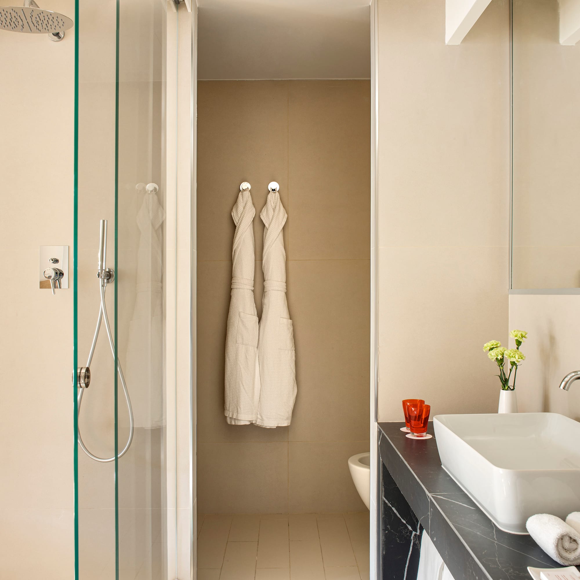 a bathroom with white towels on the wall