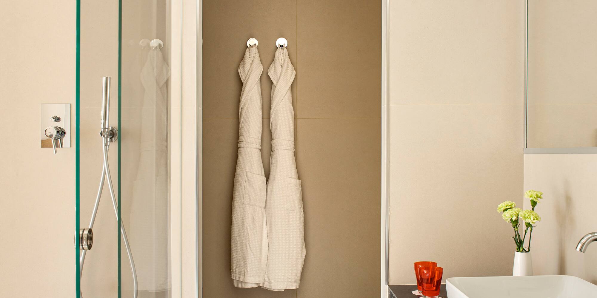a bathroom with white towels on the wall