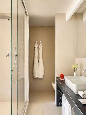 a bathroom with white towels on the wall