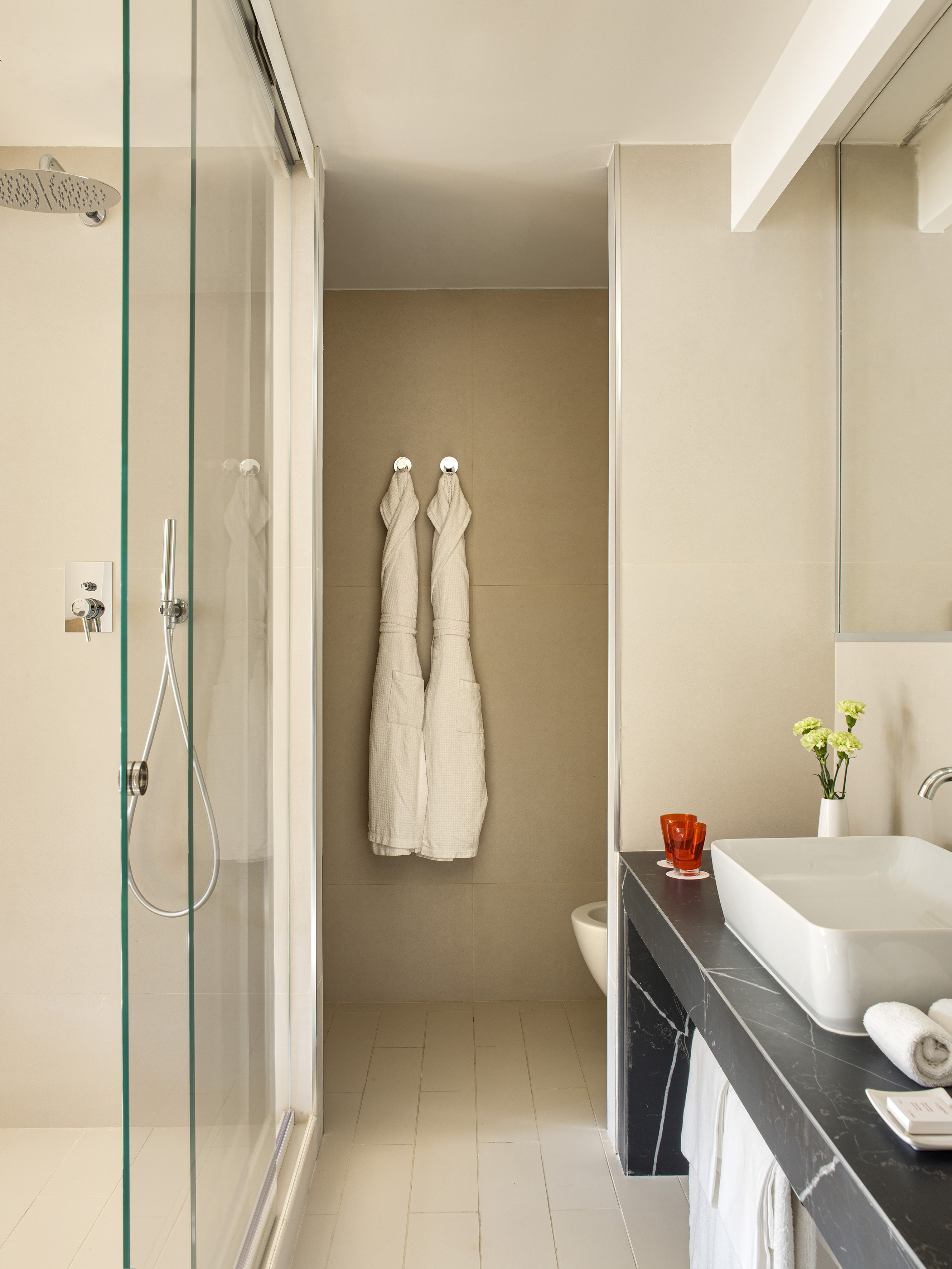 a bathroom with white towels on the wall